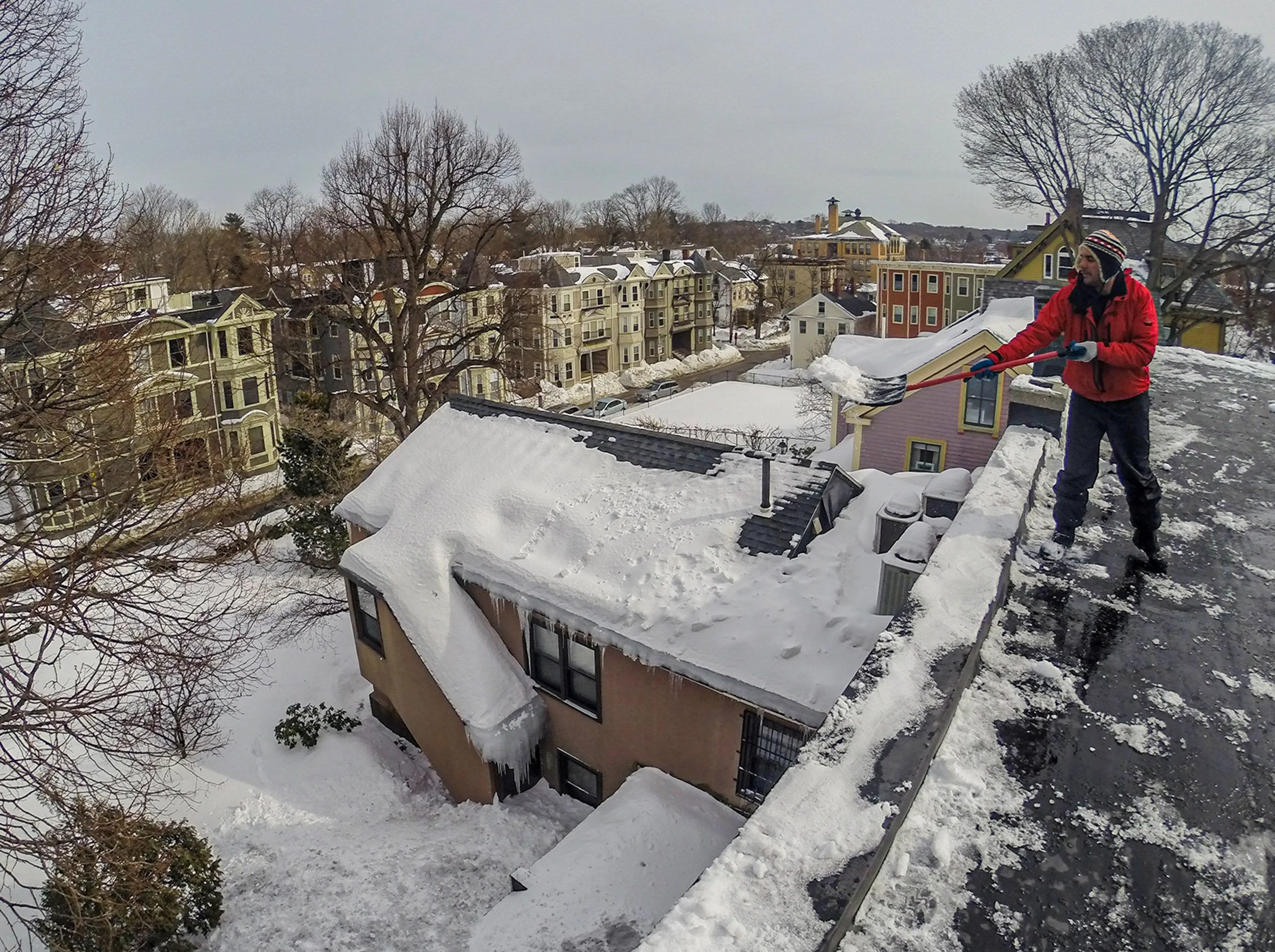  Worker clearing a rooftop in the Jamaica Plain section of Boston.  The city received more than 100 inches that winter. (Feb 2015) 