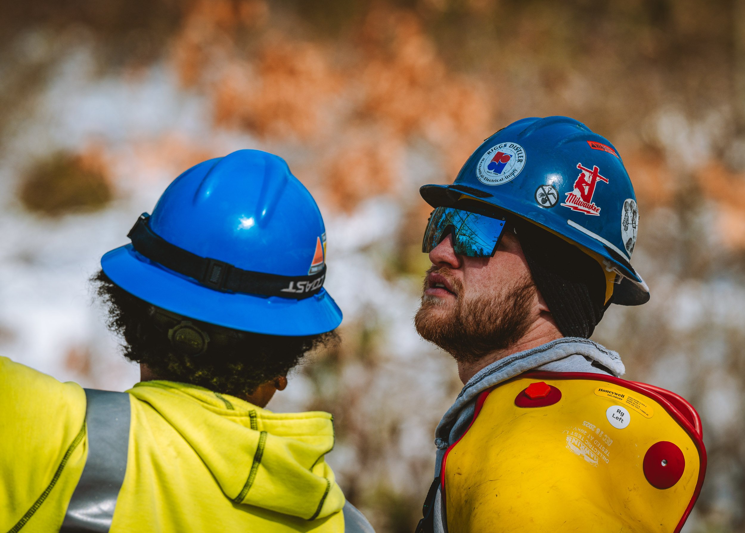 Feb 2026 - Workers looking up at newly strung electrical lines. 