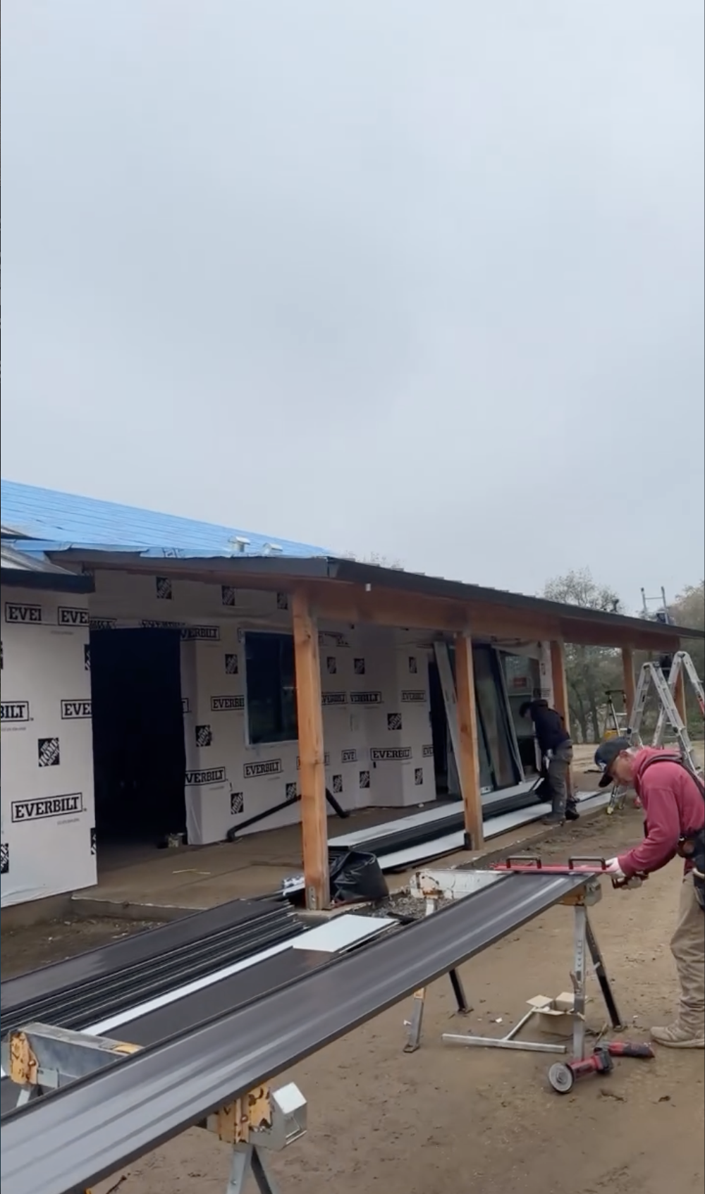 Construction workers install siding on a house under construction in Hollister, CA.