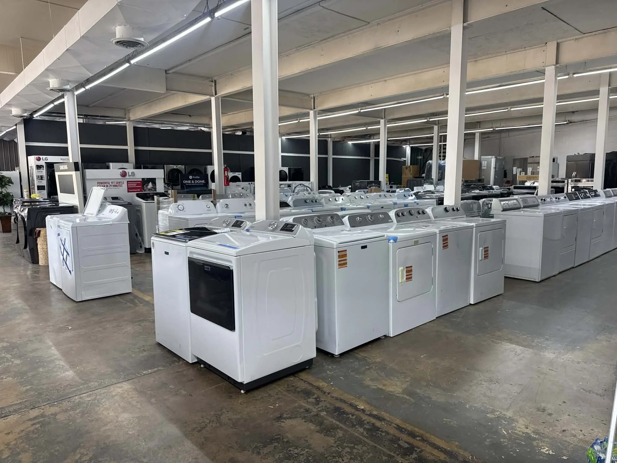 A discount appliance outlet showroom featuring open box and scratch & dent washer dryers on sale.