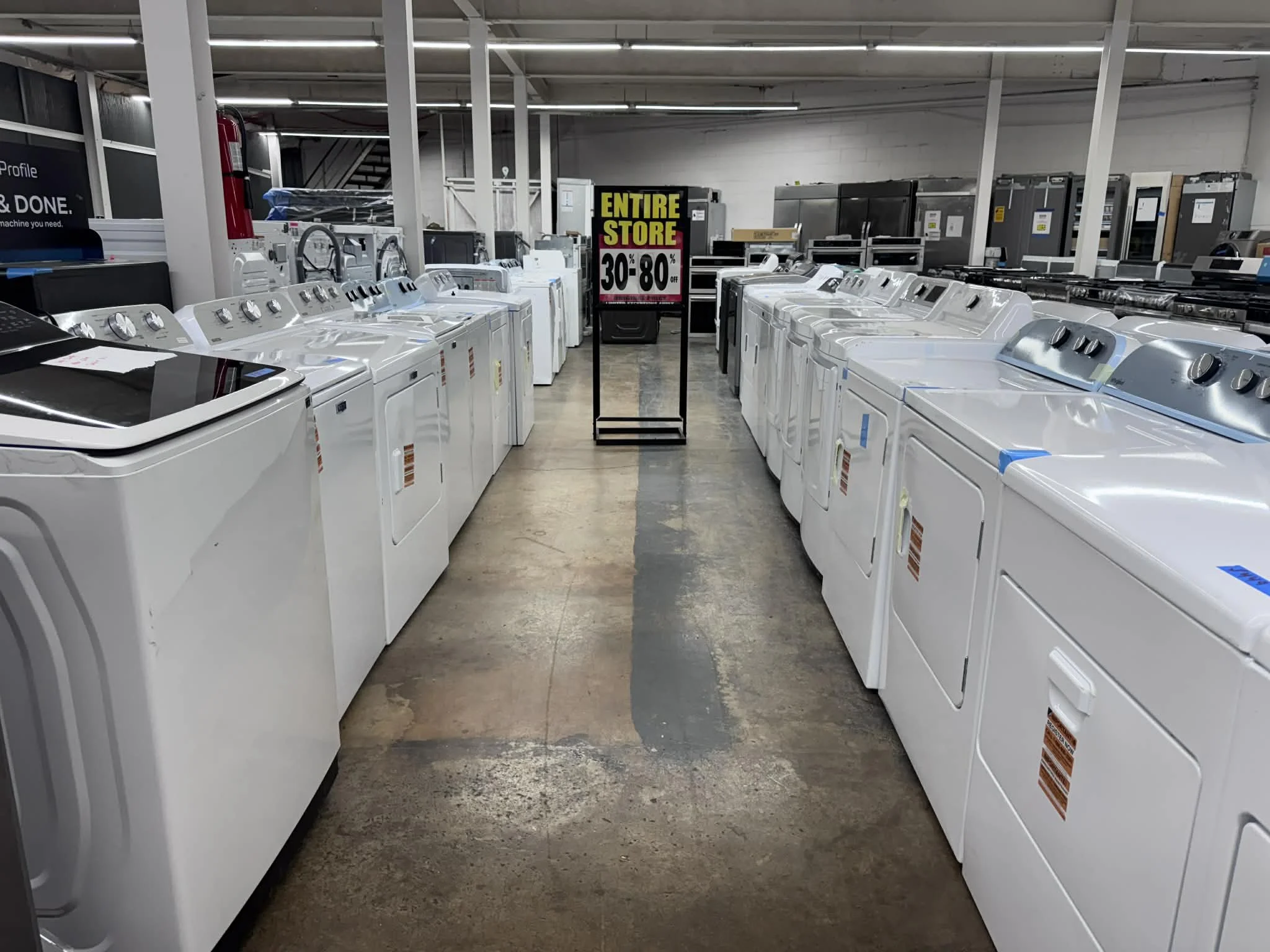 A row of discount open box washing machines and dryers on 30-80% clearance in Huntsville, AL
