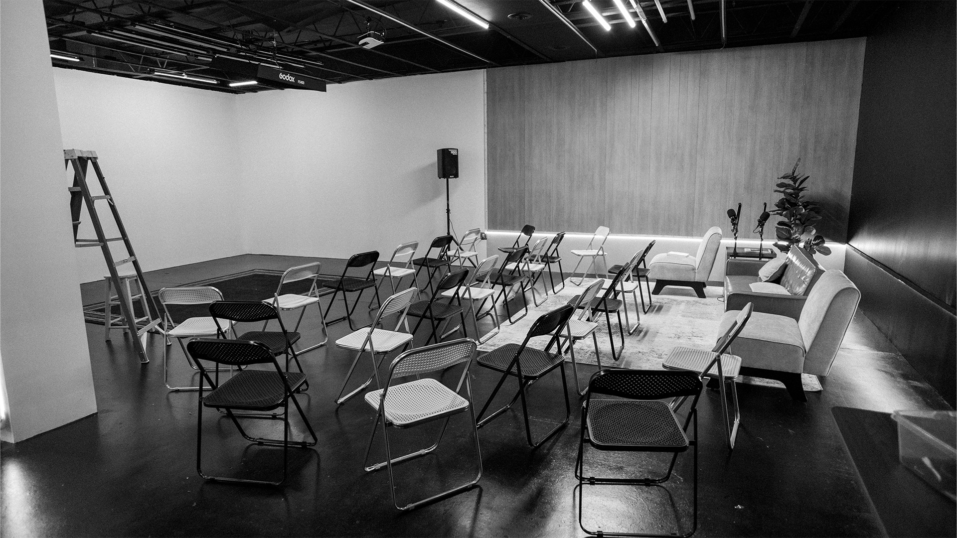 Wide view of the studio with rows of event seating.