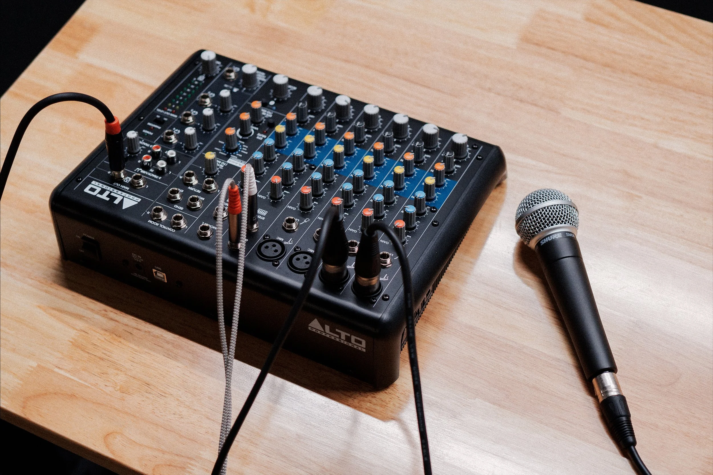 Audio mixer and handheld microphone for studio events.