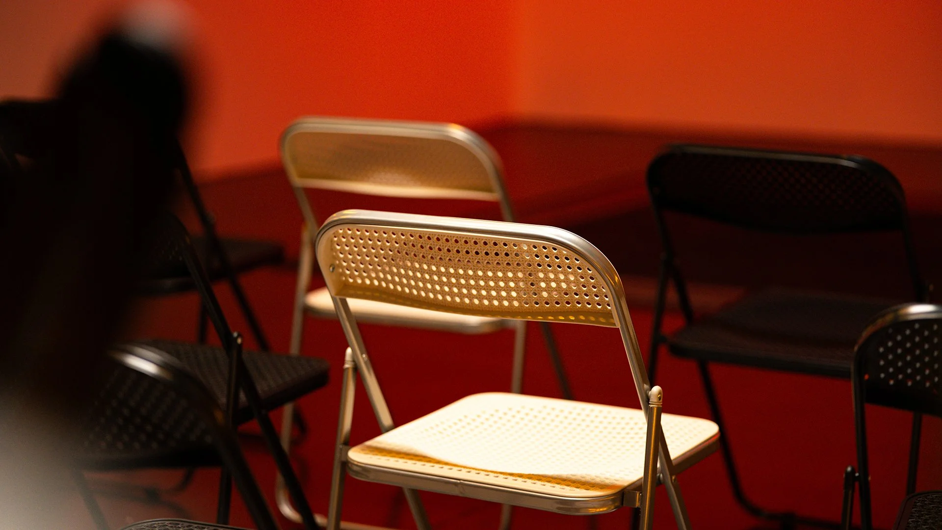 Folding chairs arranged for an intimate event at OVASEA Studios.