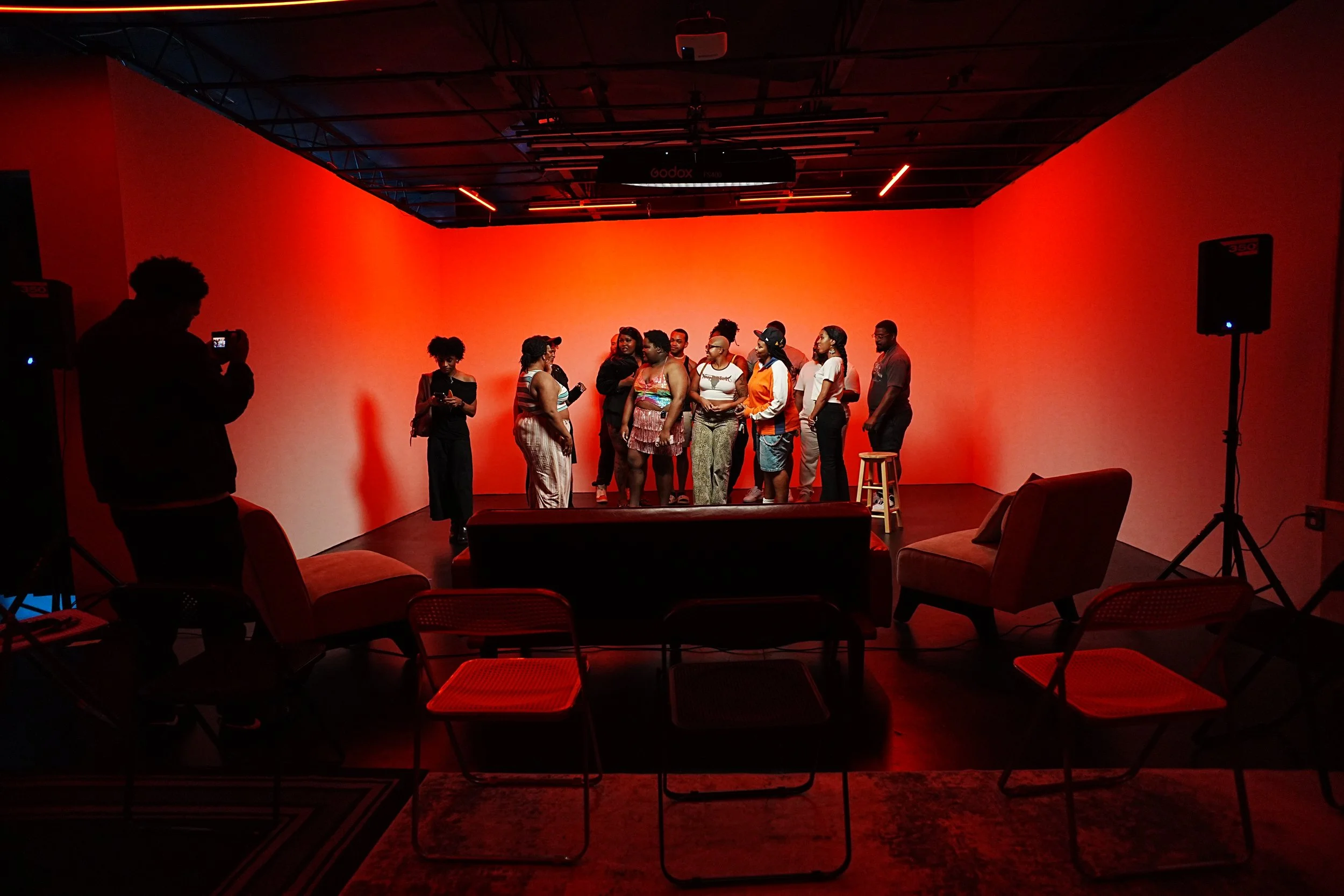 Group gathered under warm lighting at an OVASEA Studios event.