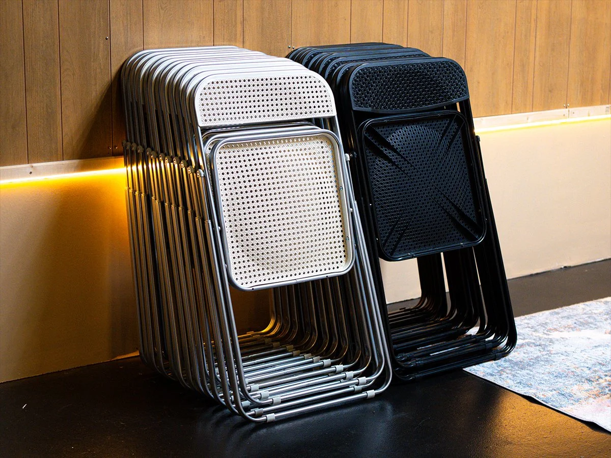 Stacked folding chairs available for studio events.