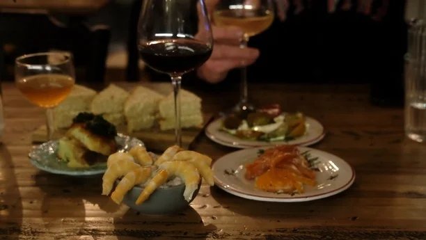 Ensemble de petites assiettes accompagnés de verres de vins rouges natures