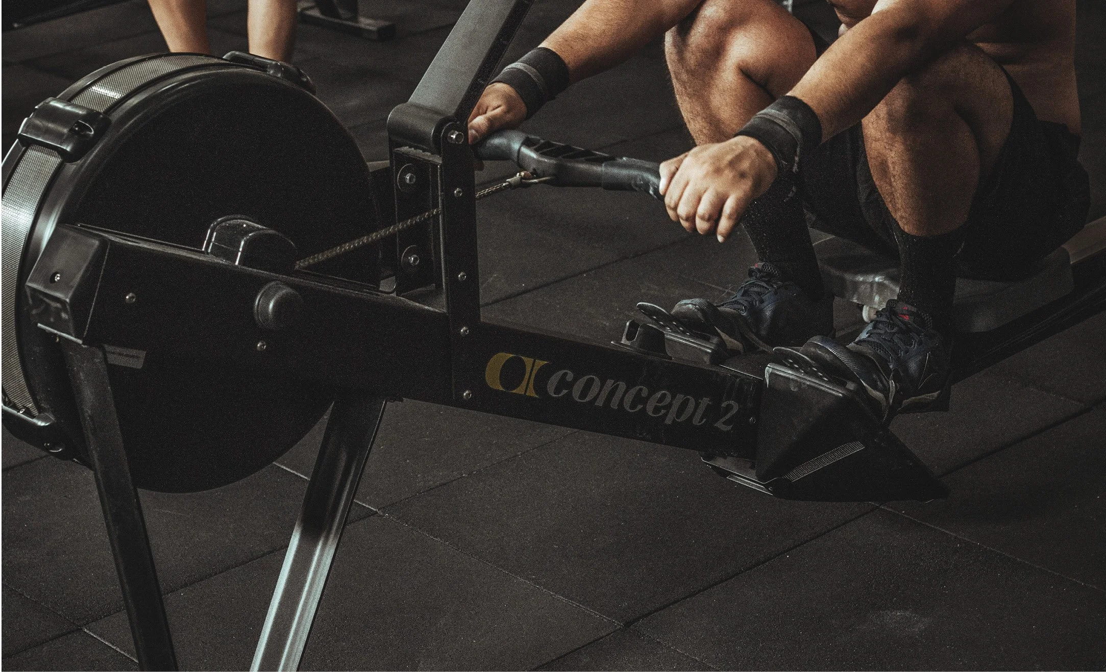 Person using a rowing machine in a gym