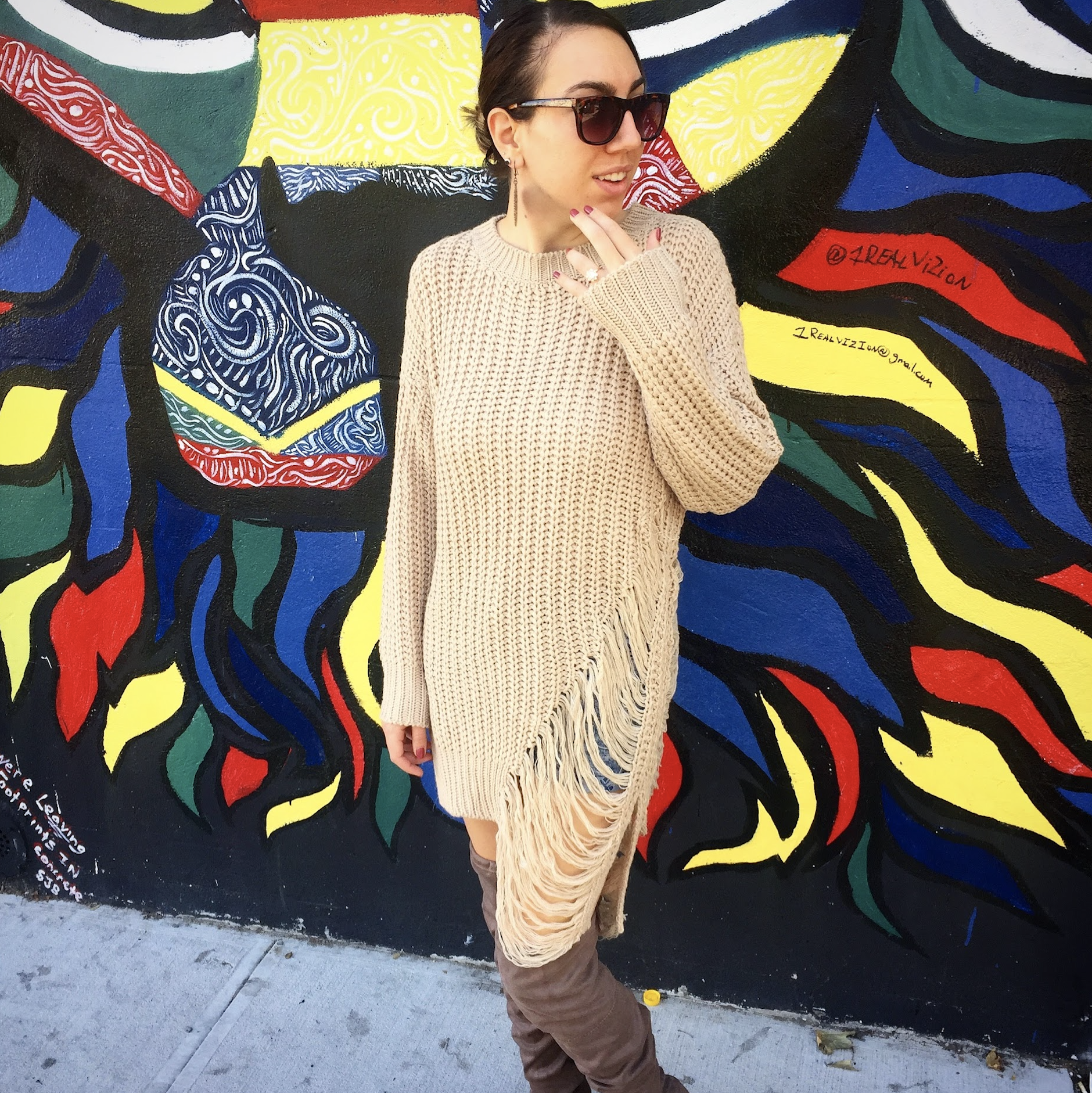 Cola, founder of The Avocado Method, wearing a distressed sweater dress in front of a colorful NYC mural, personal style consulting for real life