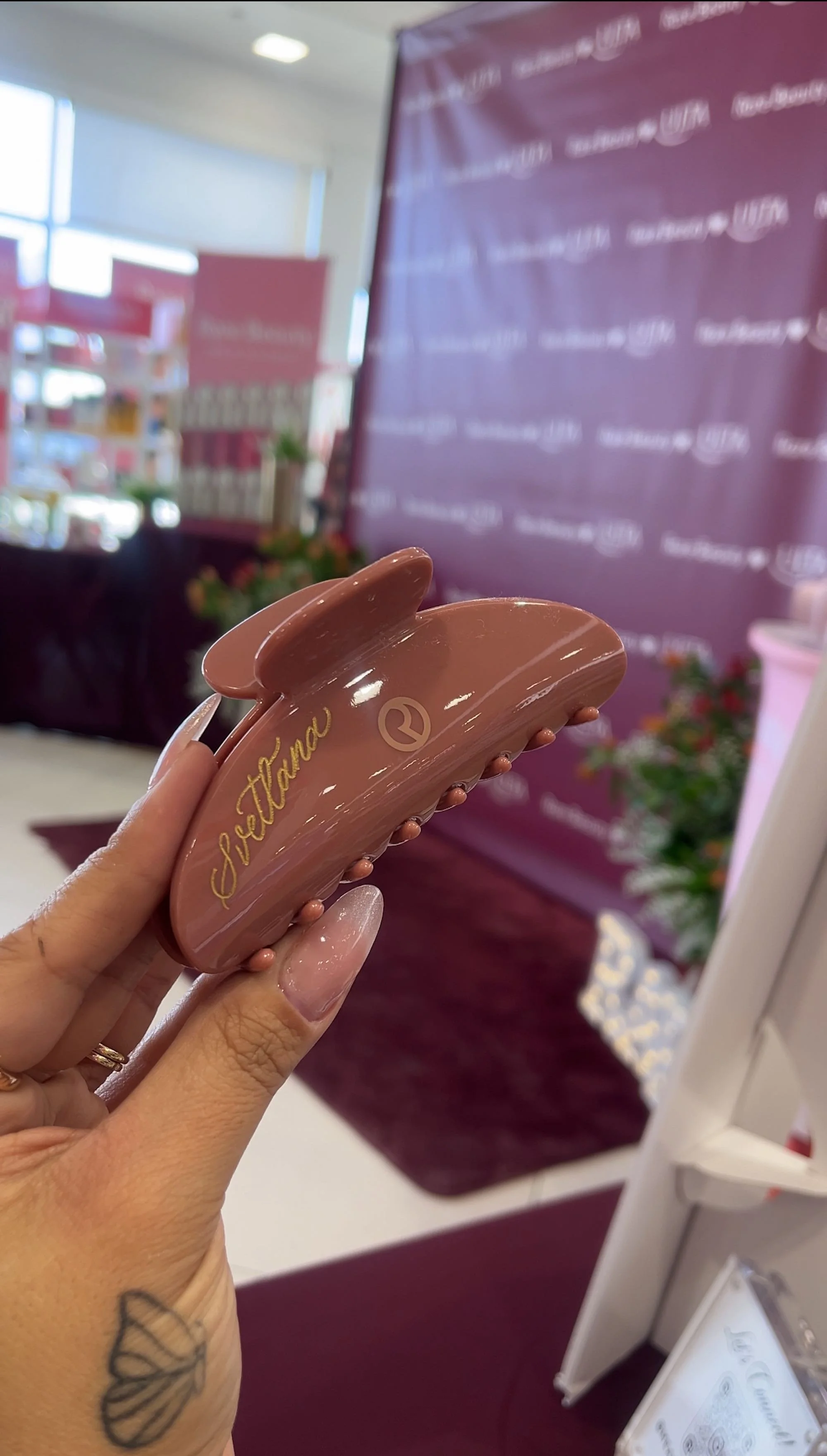 A hand holding a custom engraved hair clip