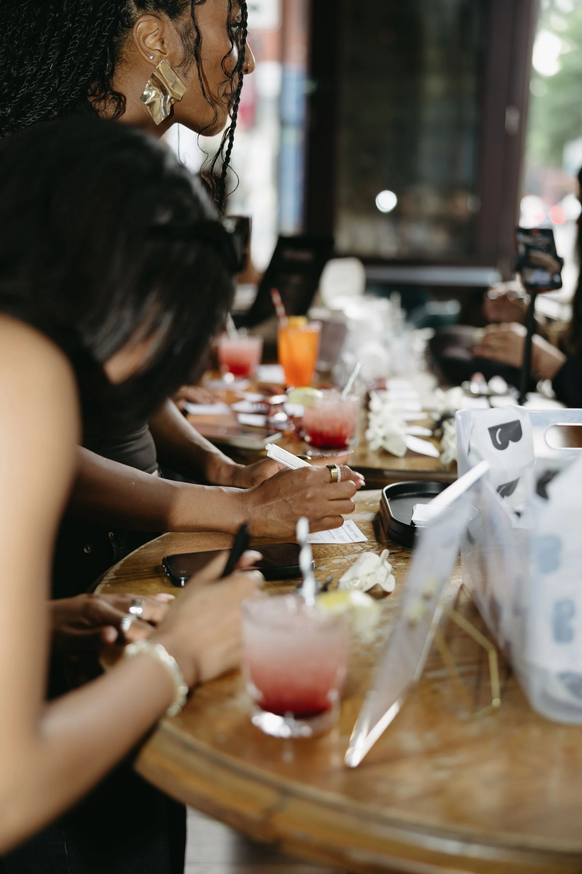 People at an event, waiting in line to have an item custom engraved.