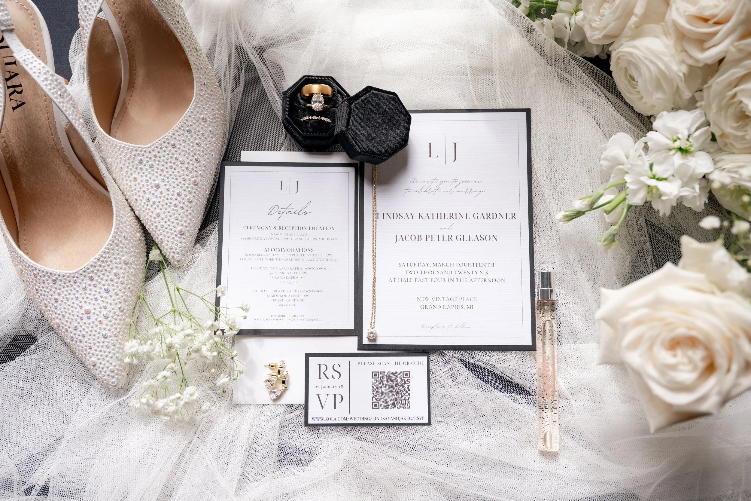 Rings, invitations, shoes, and florals in a beautiful flat lay setup.