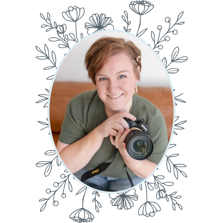 Nicole of Wild Ivy Studio, West Michigan newborn and family photographer, holding her camera