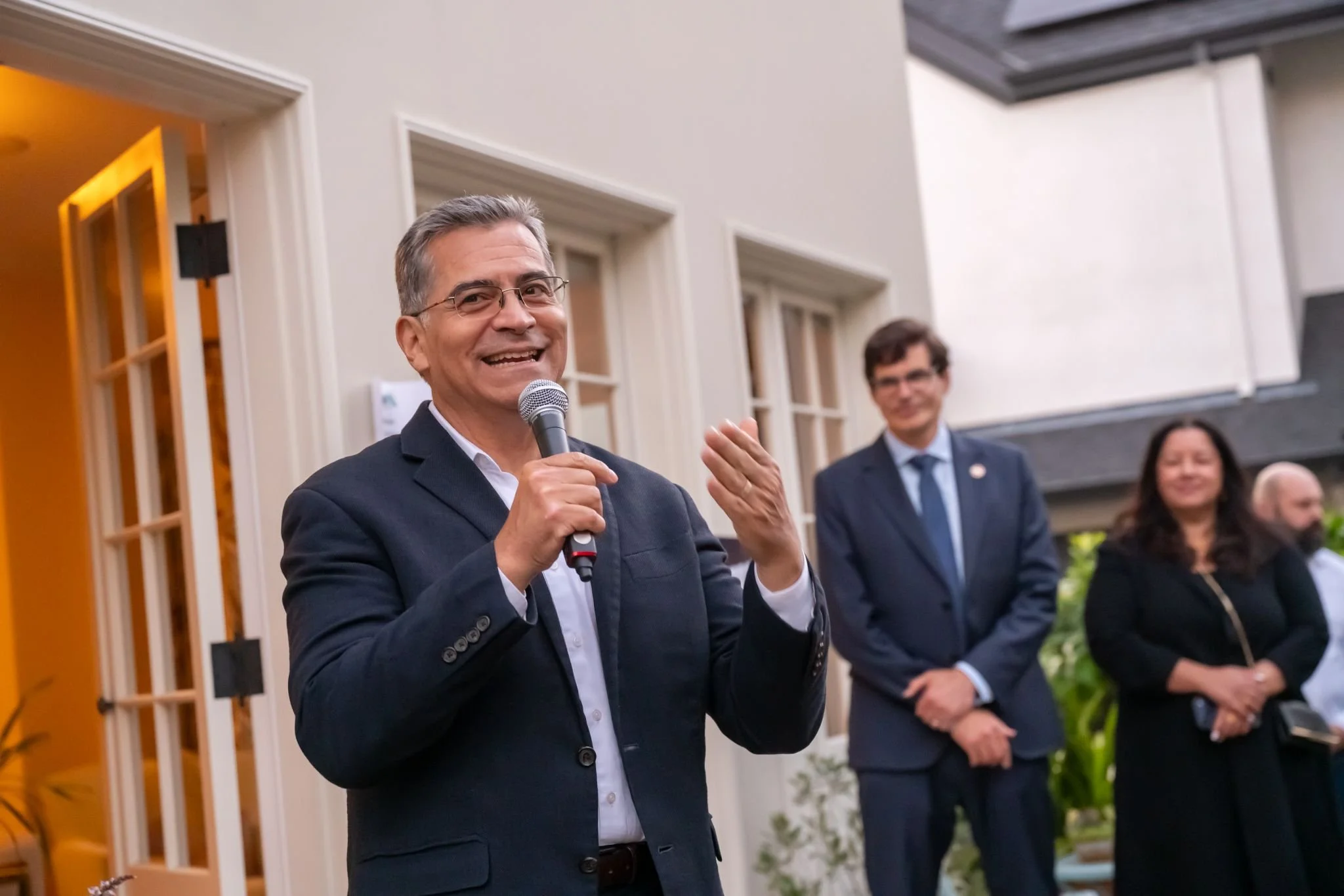 Gubernatorial candidate Xavier Becerra at a clean energy community event, with Sen. Josh Becker in the background