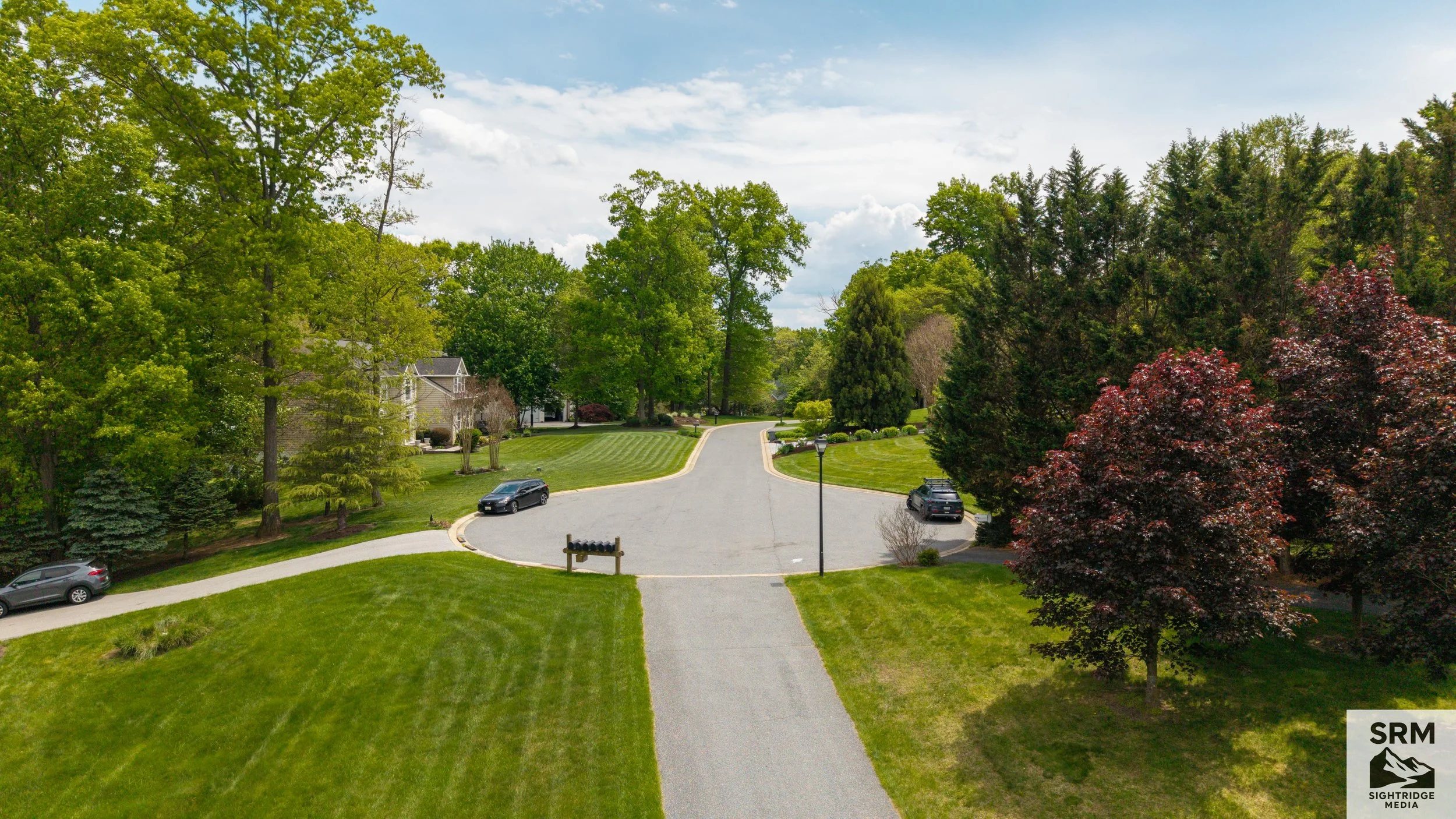 Property Approach — Low aerial showing driveway, landscaping, and curb appeal — Parkton, MD.