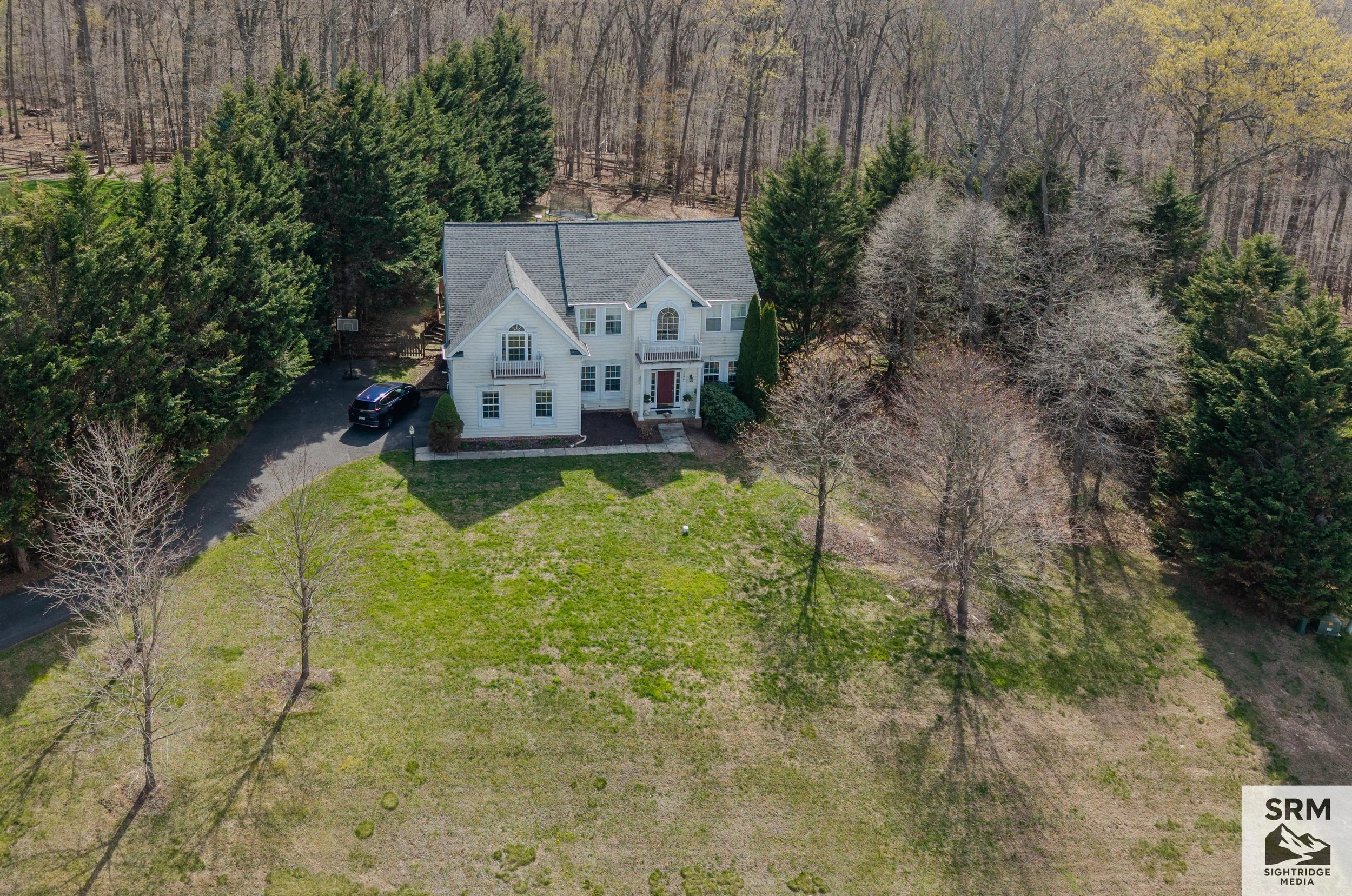 Residential Aerial — Wide overview showing full property, tree line, and surrounding land — Parkton, MD.