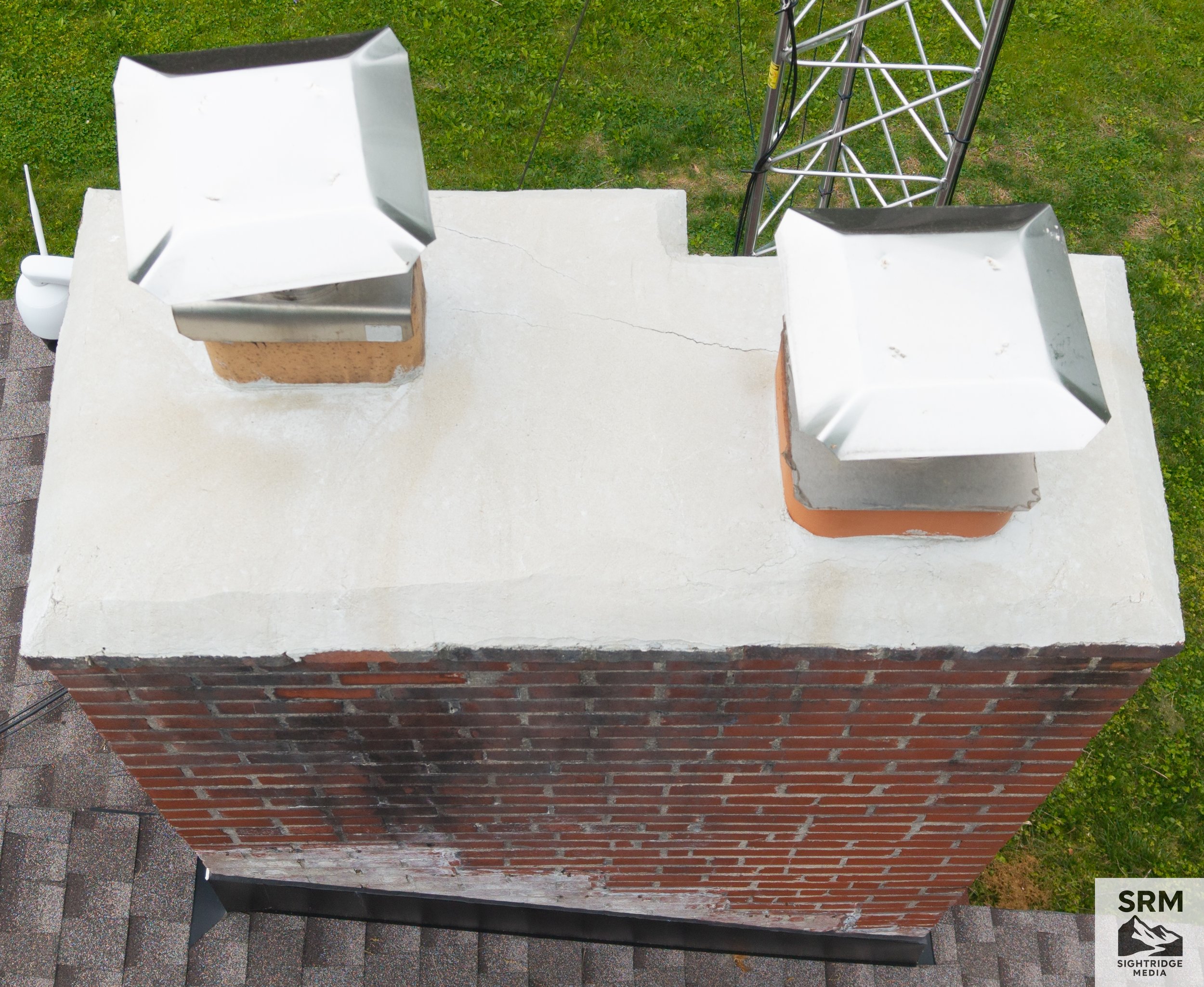 Chimney Crown Detail - Aerial close-up of chimney crown showing mortar condition, cracking, and weathering — critical inspection point for water intrusion.