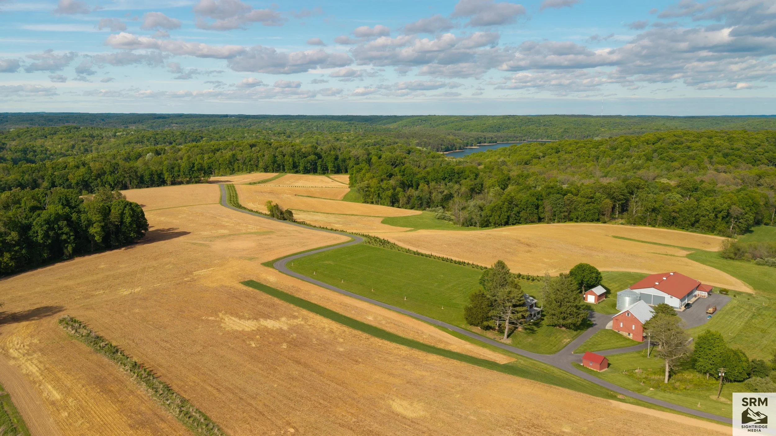 Aerials & Landscapes: a homestead set among rolling farmland and tree lines in mid-morning light. A view of home worth hanging on the wall. Photo featured in LocalNews1 of Franklin County, PA and Washington County, MD.
