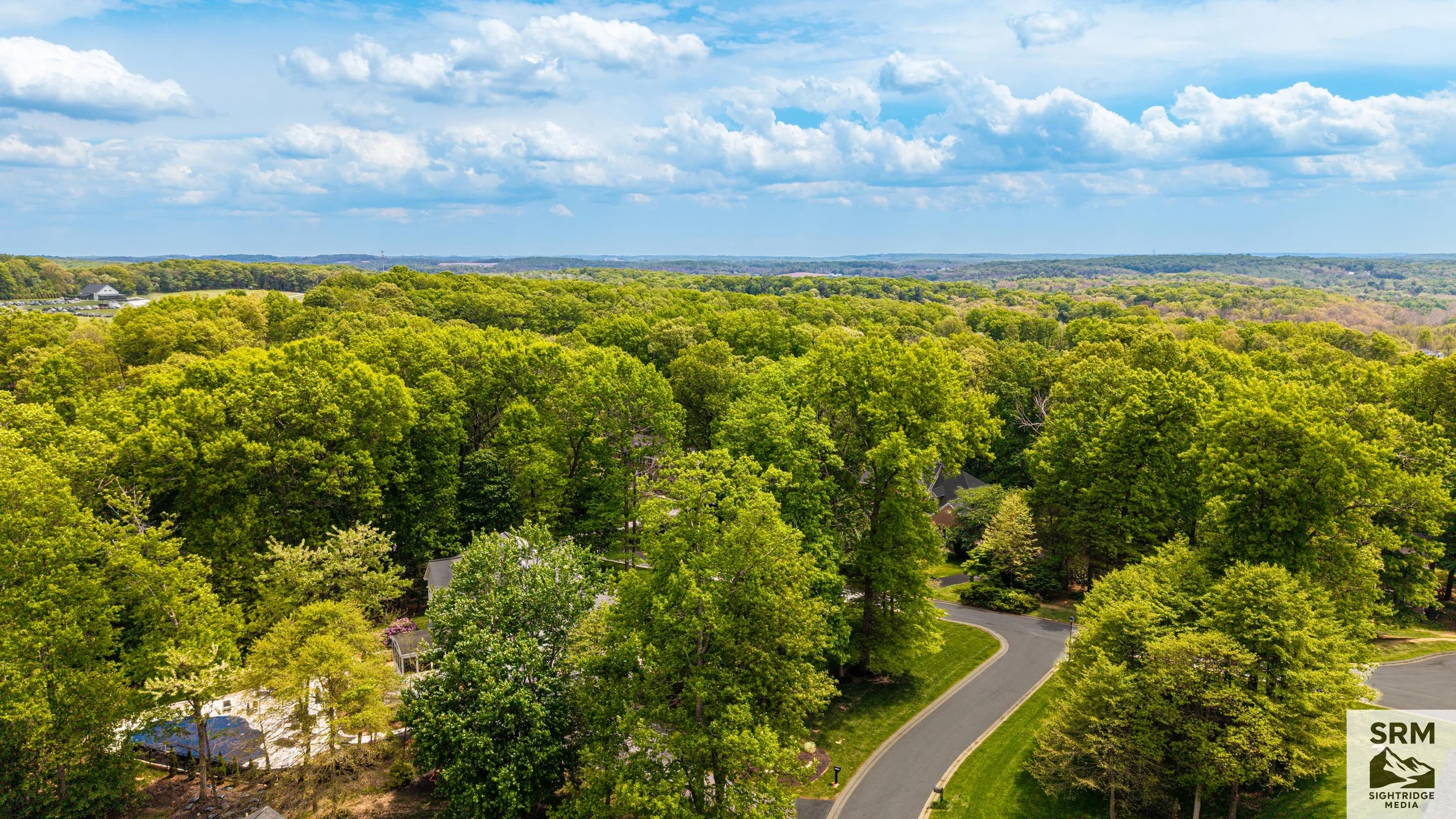 Aerial Landscape View — Wide shot showing property in context of surrounding neighborhood and tree canopy — Parkton, MD.