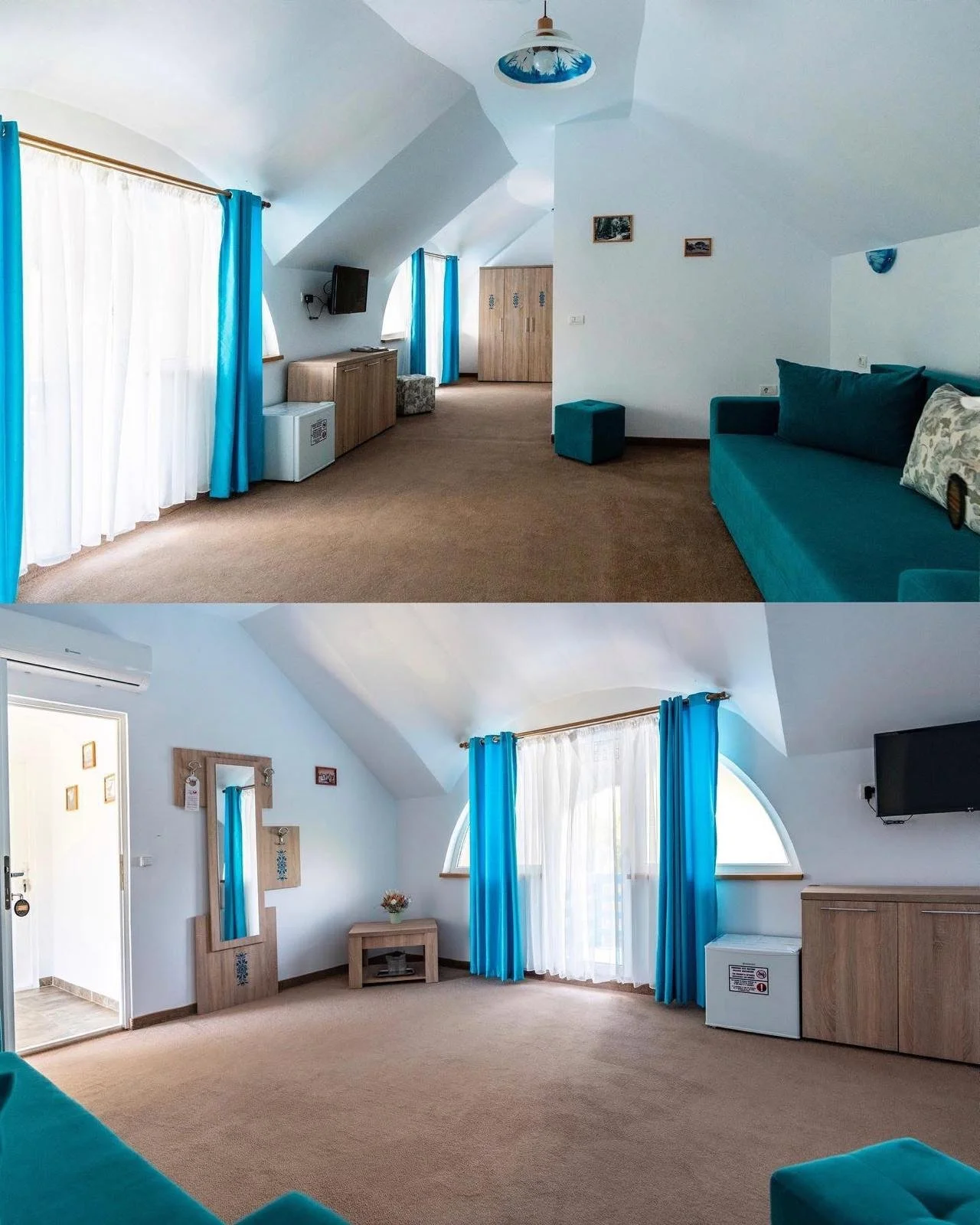 A bright hotel room with white walls, blue curtains, a turquoise sofa, and a flat-screen TV mounted on the wall.