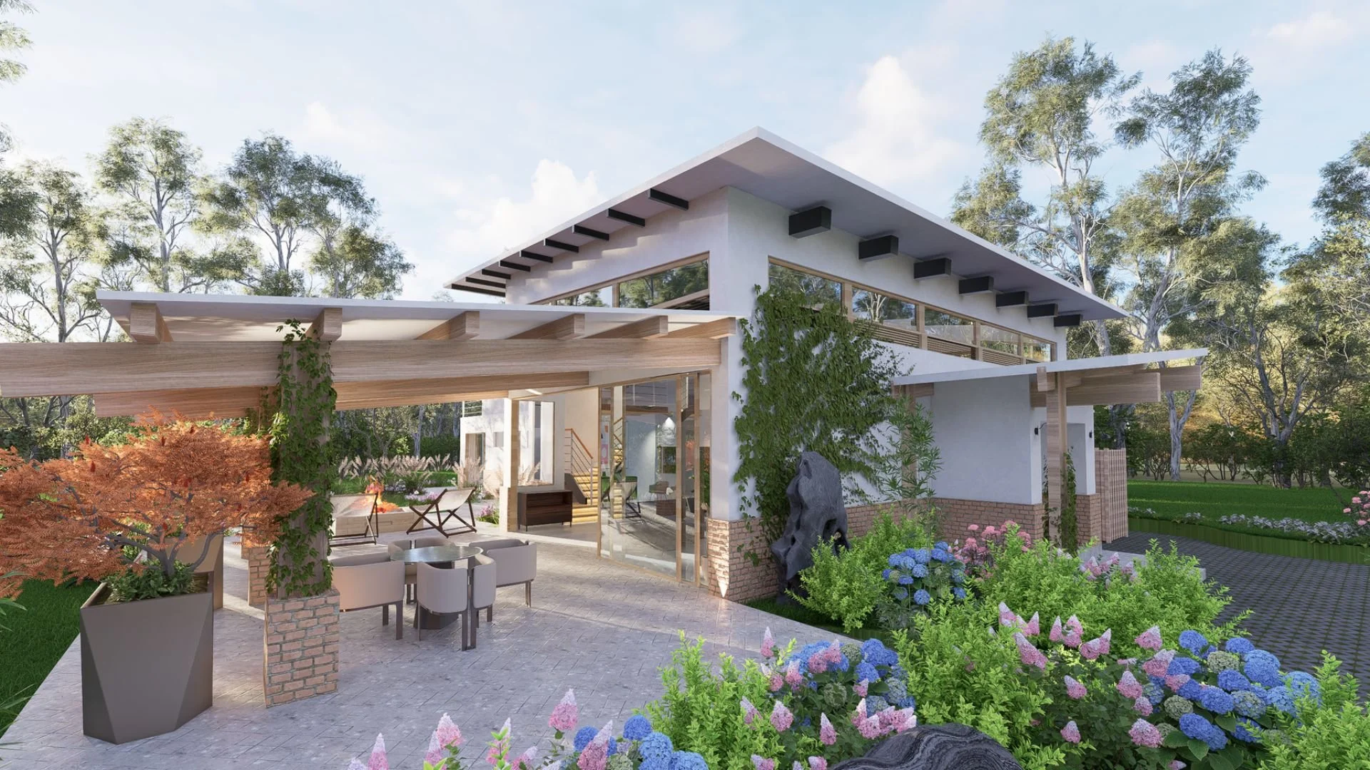 Modern house with outdoor patio, surrounded by trees and blooming flowers.
