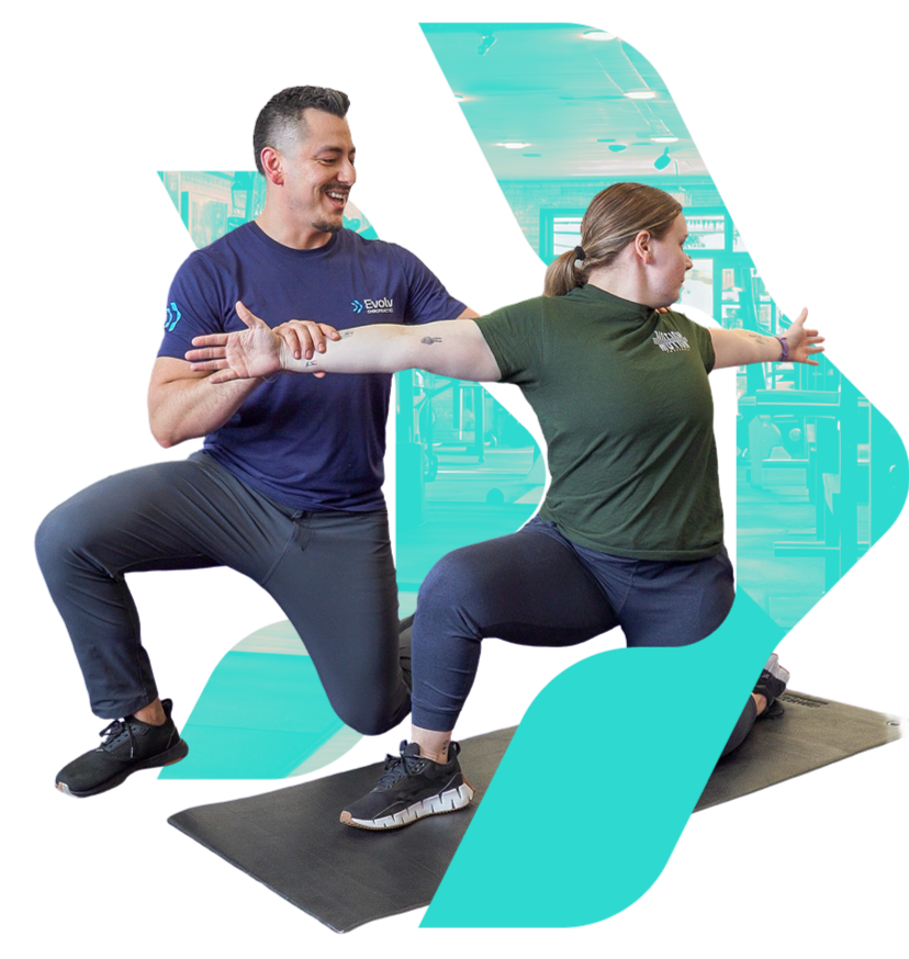Dr. Cruz guiding a patient through a movement assessment at Evolv Chiropractic in Dallas