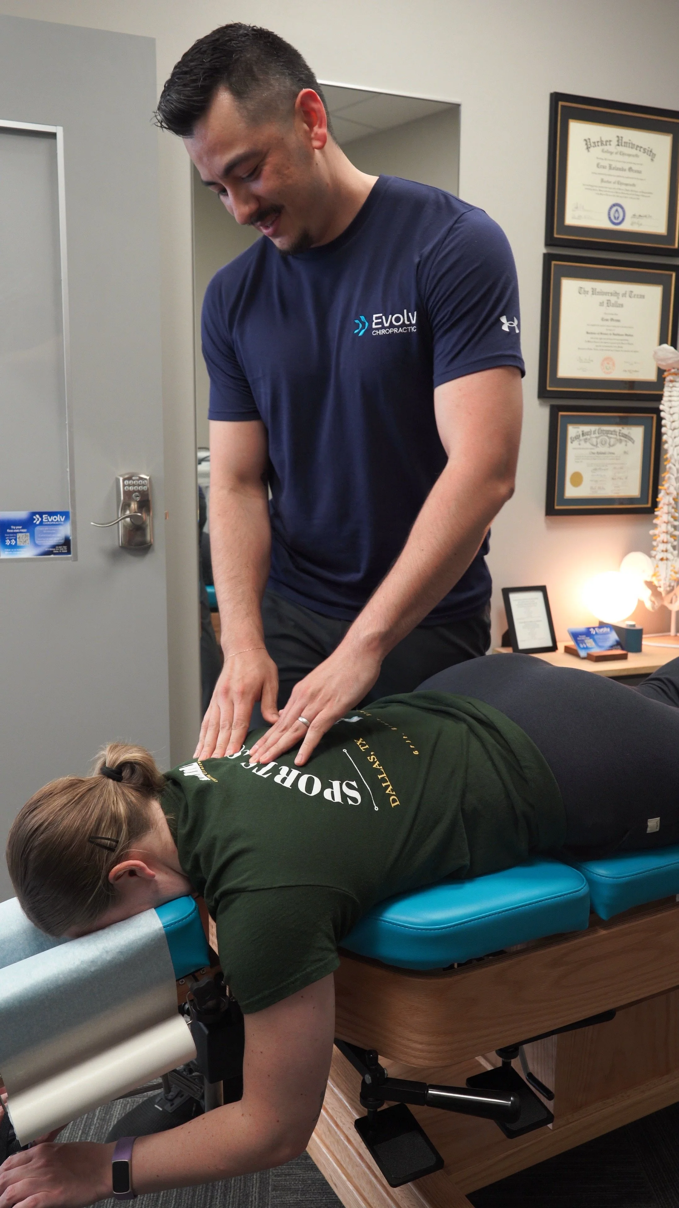 Hands-on chiropractic care during a treatment session at Evolv Chiropractic