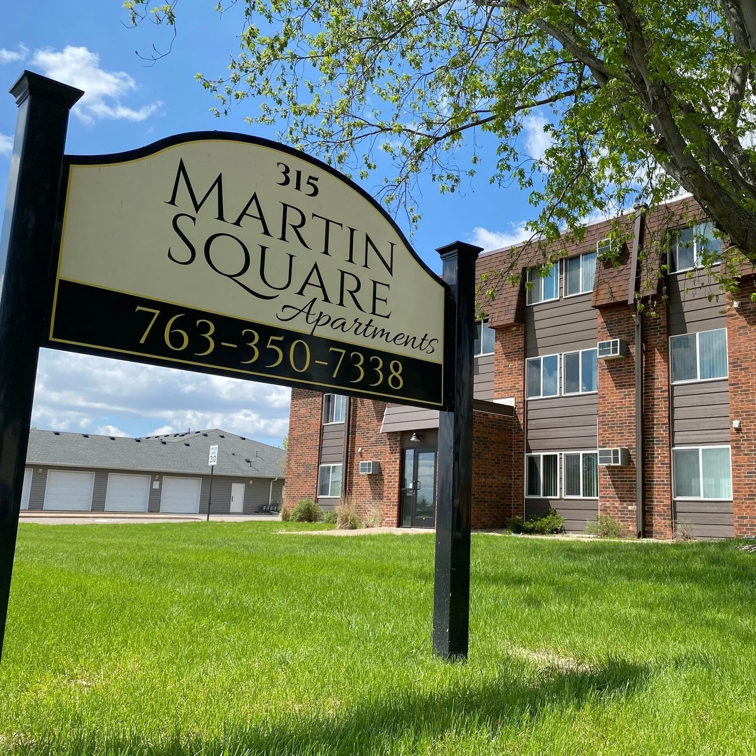 Grounds feature mature trees and well kept lawns with picnic tables and more