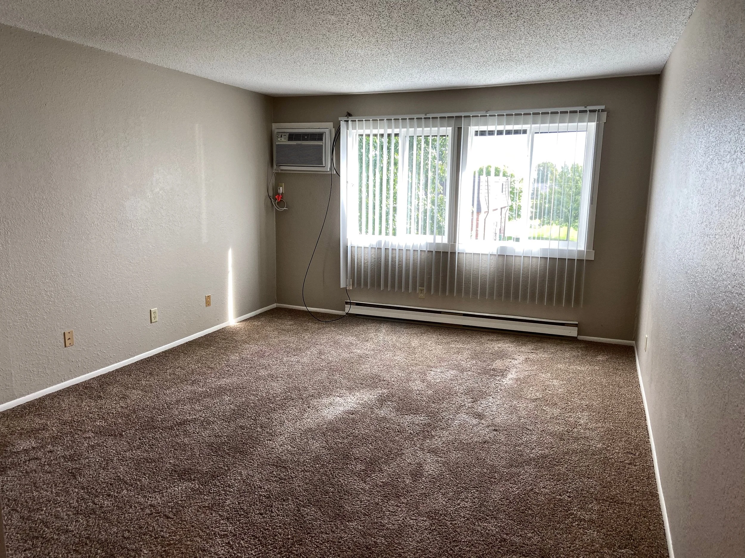 Spacious living rooms with double wide windows allow light and warmth throughout