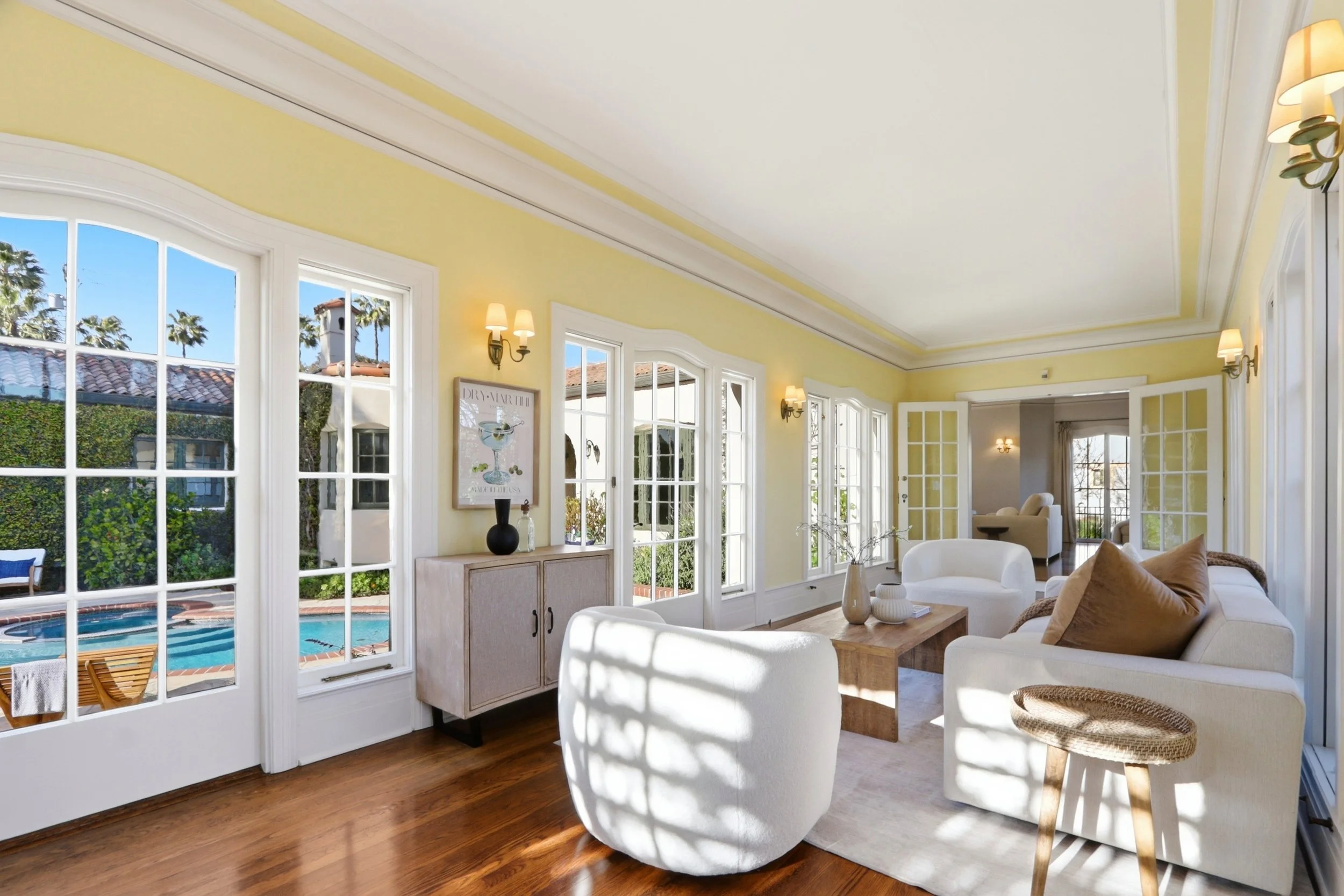 Sunroom provides flexible entertaining space with seamless access to the pool and private courtyard.