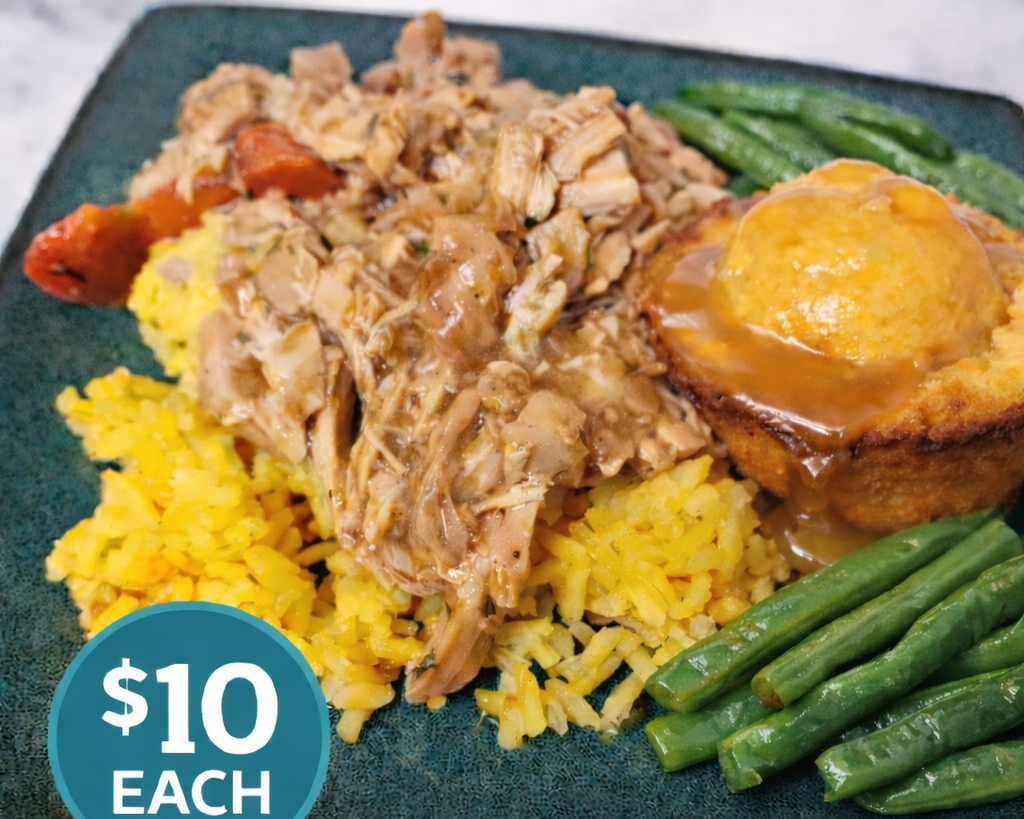Plate with yellow rice, shredded chicken with gravy, green beans, and a baked potato topped with cheese and gravy. Price tag indicating $10 each.
