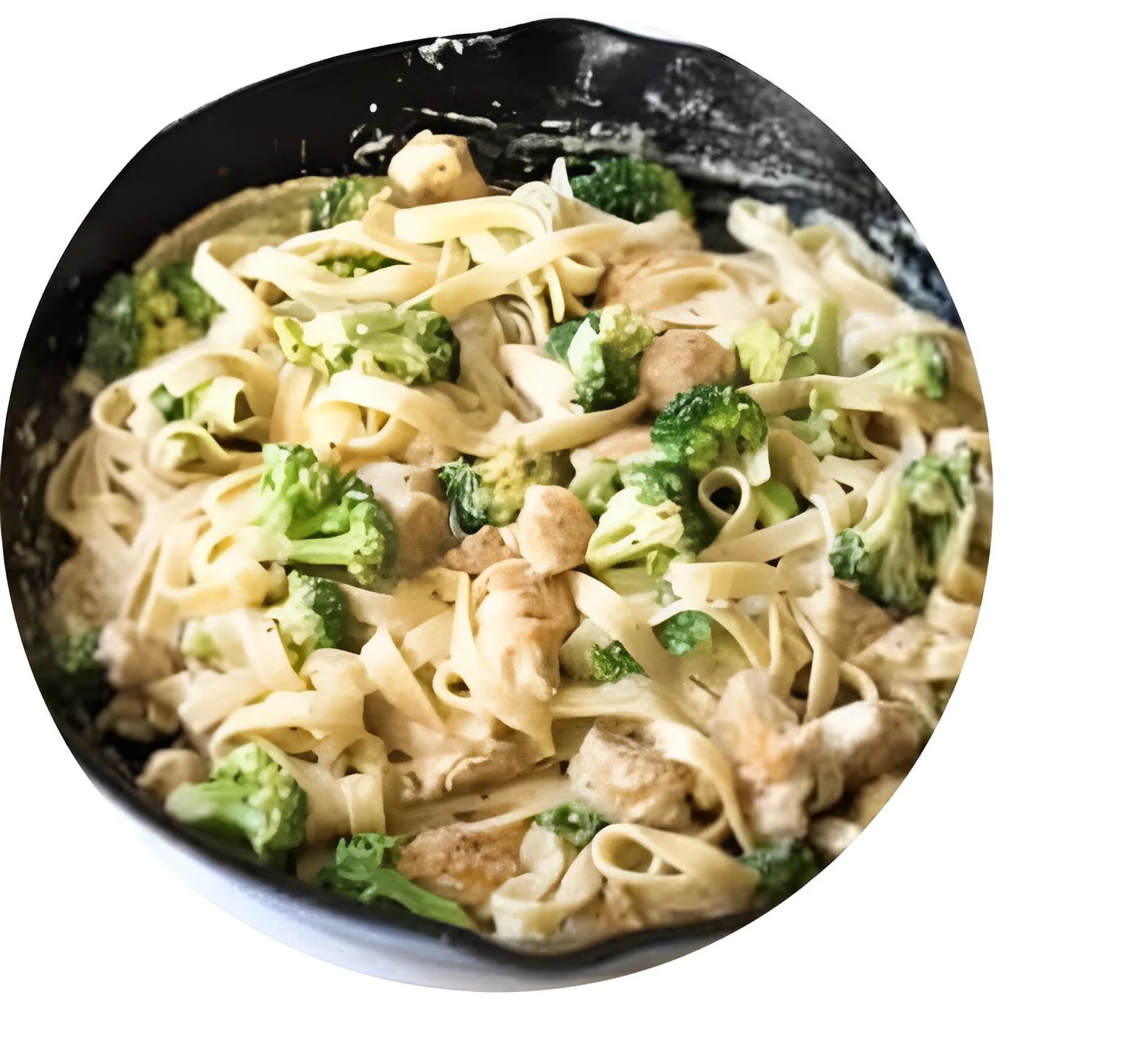 Close-up of a bowl of chicken and broccoli Alfredo pasta.