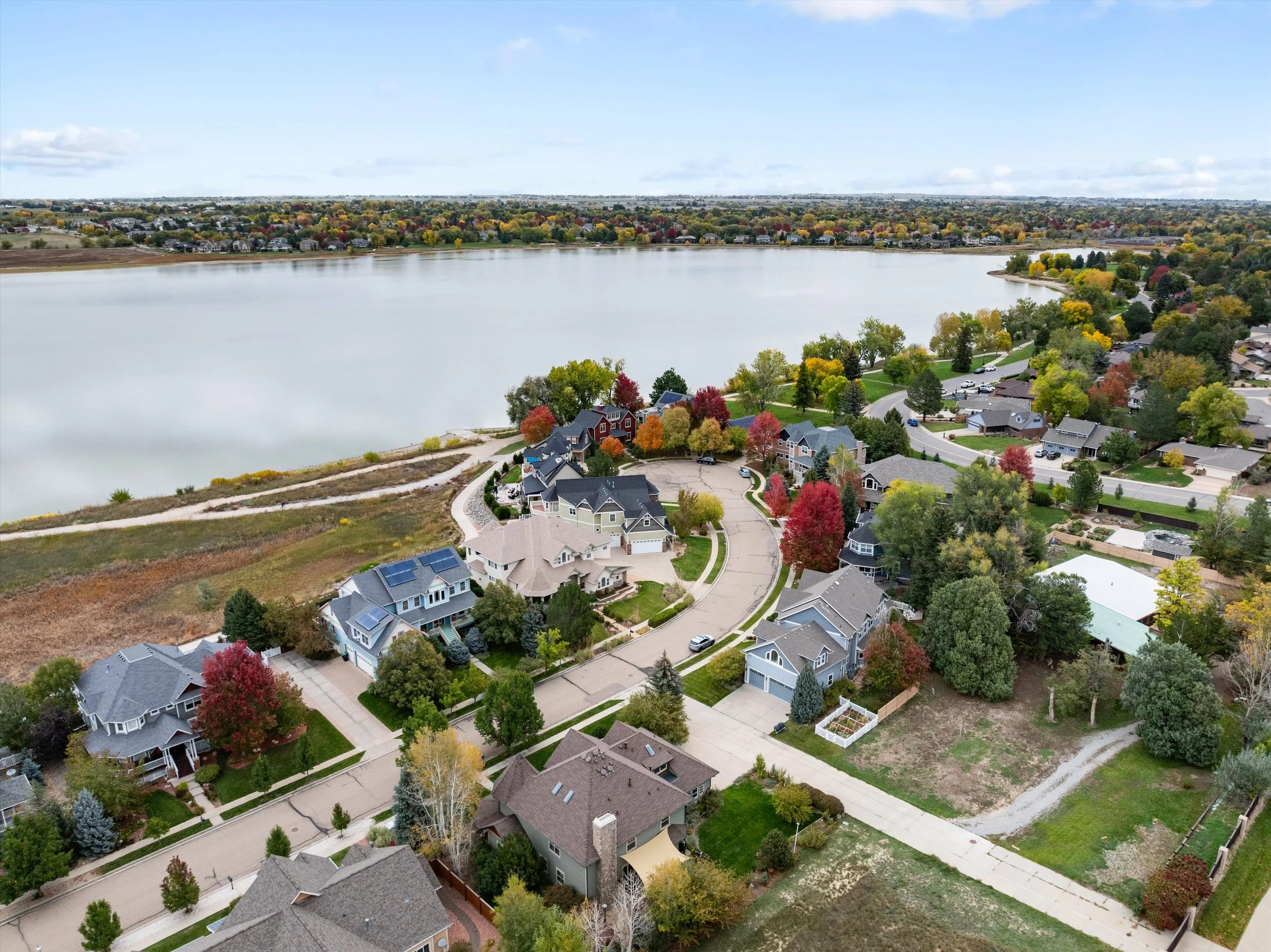 Aerial view of a McIntosh Farm neighborhood in Longmont, Co. Listed by Logan Schlutz. Steps from Lake McIntosh. 