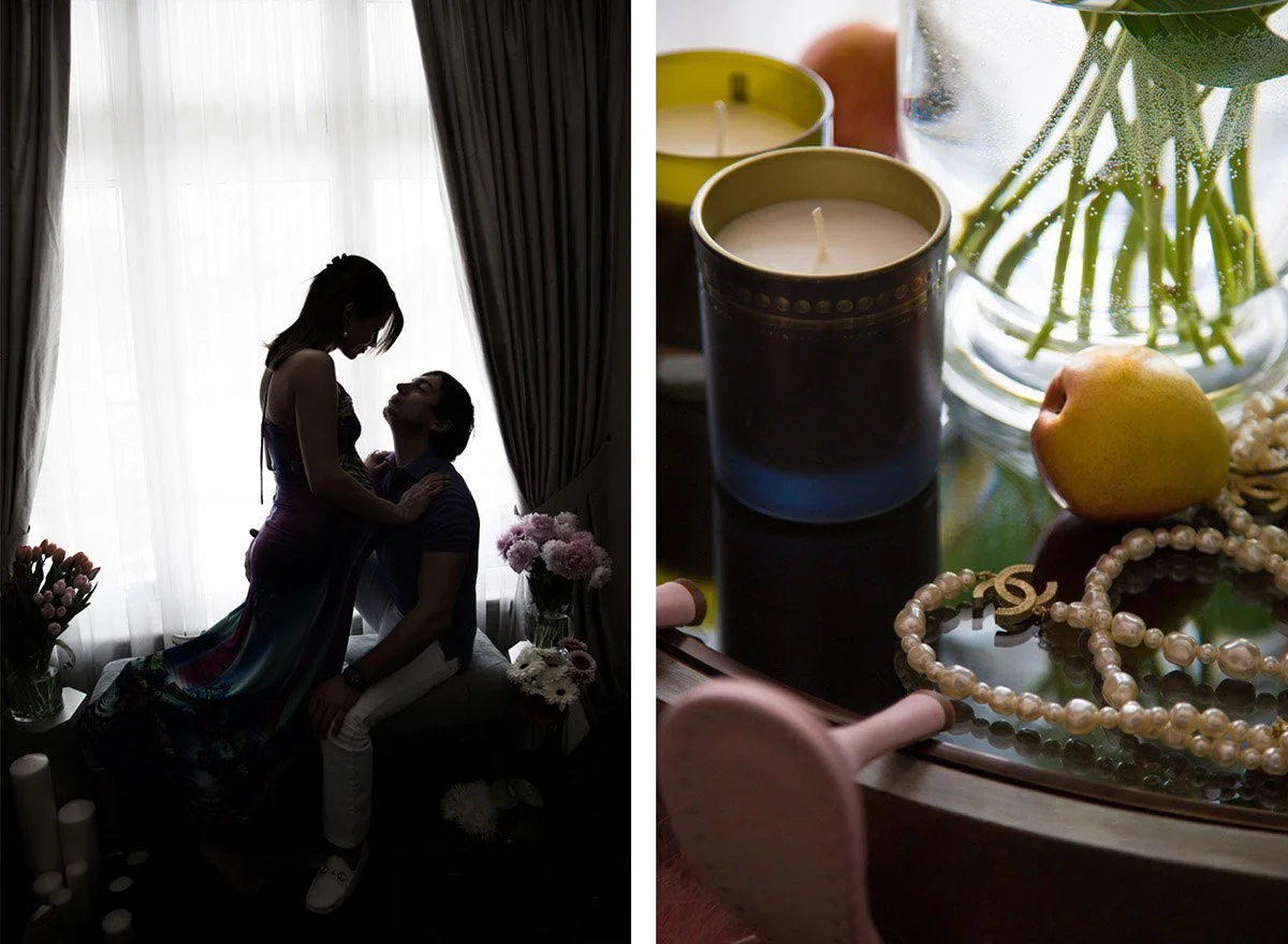 Silhouetted couple in a romantic embrace near a window with curtains, flowers, and candles on the side; close-up of candles, a pear, pearl jewelry, and a potted plant on a wooden table.
