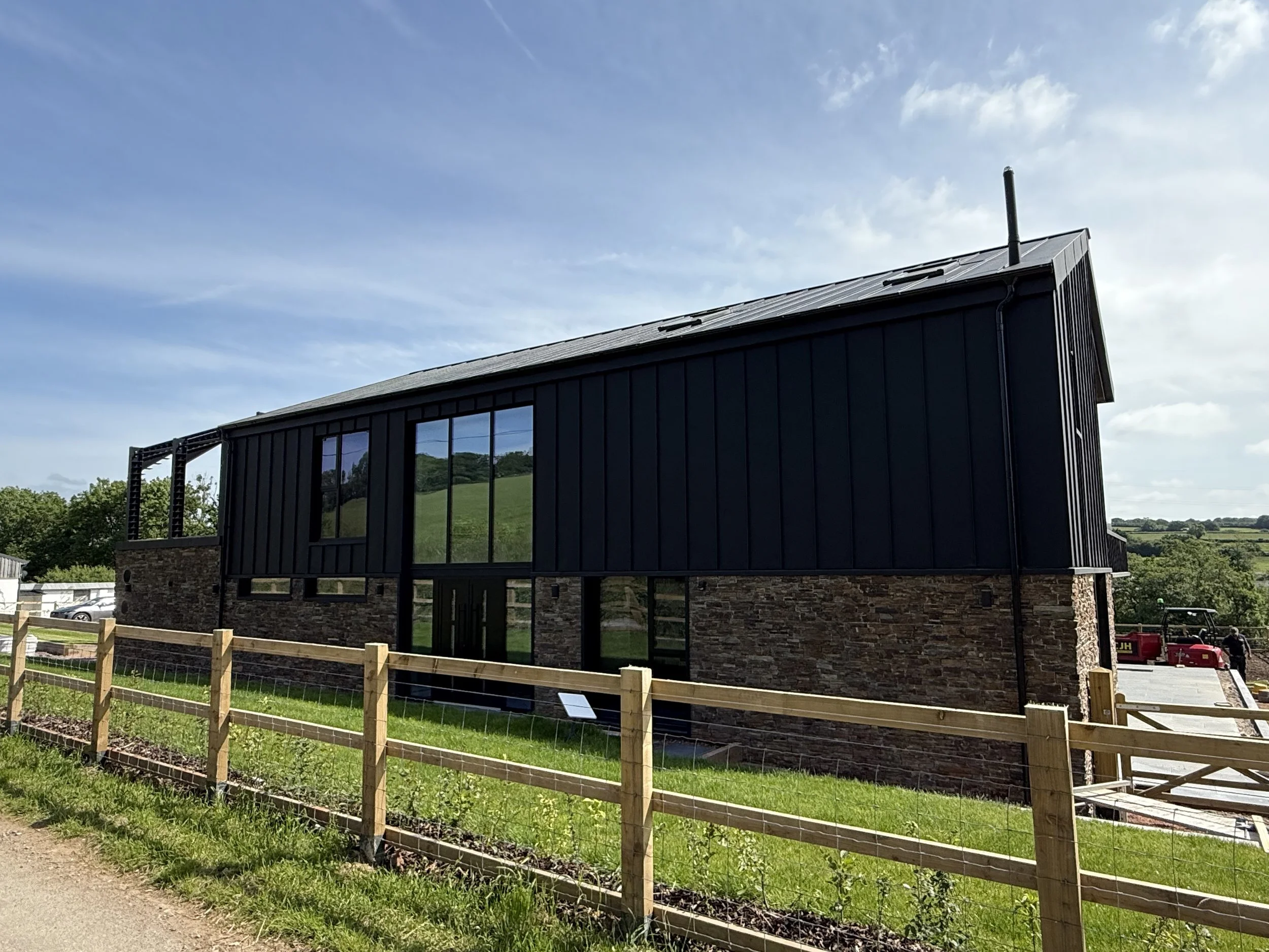Modern contemporary dwelling, with black zinc cladding with extensive glazing, constructed in a highly efficient airtight timber frame by Weststructure. 