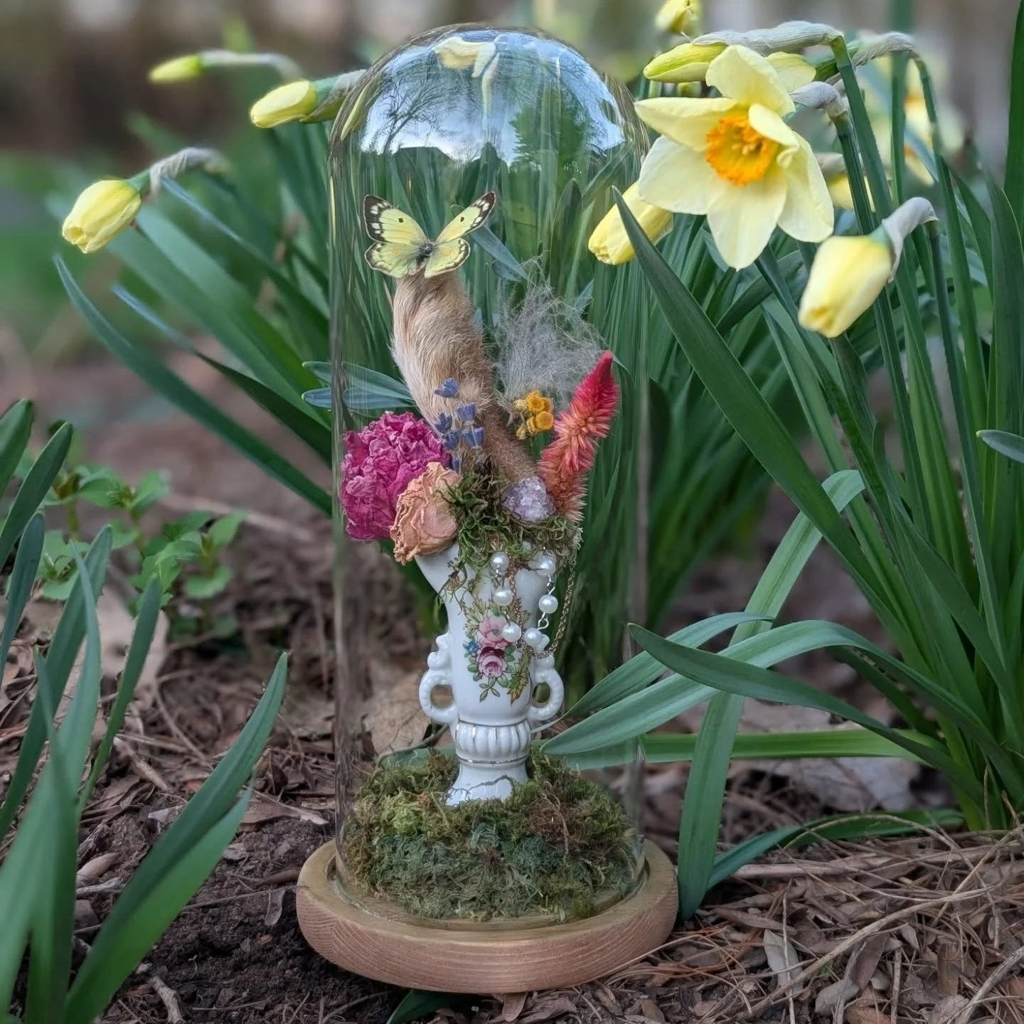 Can you guess what the rabbit's foot is displayed on?

Lucky rabbit foot with clouded sulphur butterfly, prairie smoke and mixed florals sitting on a vintage ____________.
.
.
.
#vultureculture #itwasdeadwhenwemet #luckyrabbitsfoot #oddityart #fillin