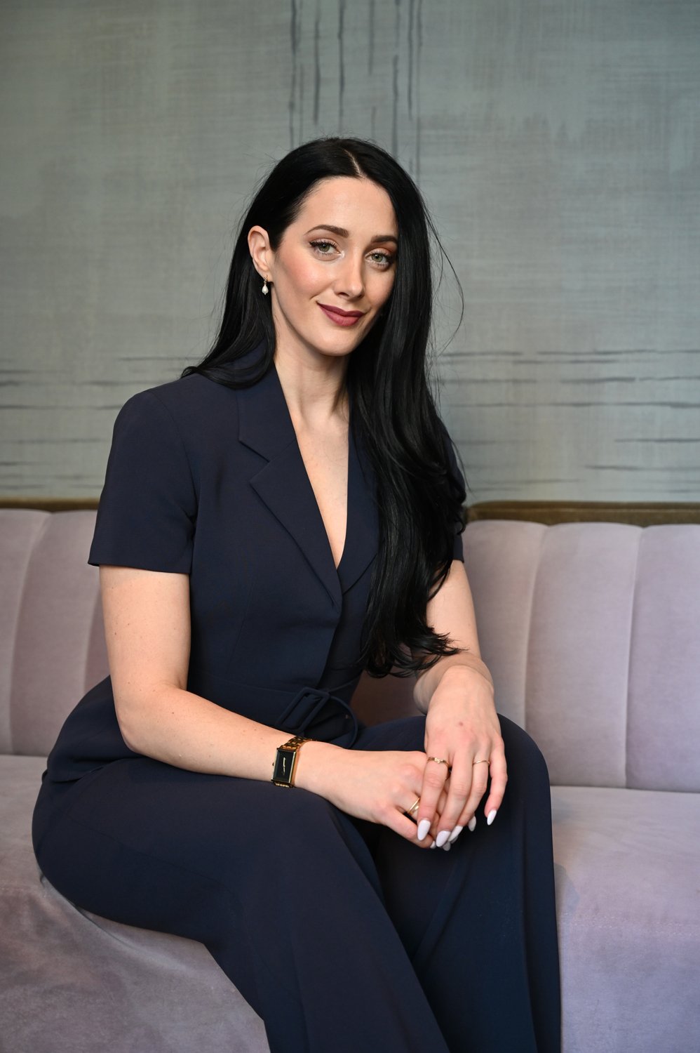 Wellness practiced at the advisory level fit and successful woman sitting on a couch