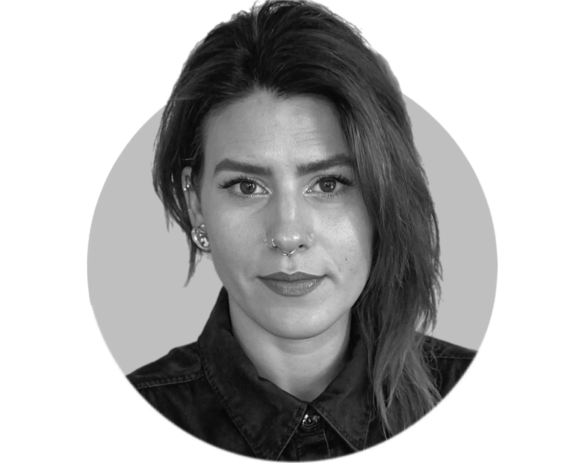 Black and white portrait of a woman with dark hair, light skin, and eye makeup, wearing earrings and a dark top.