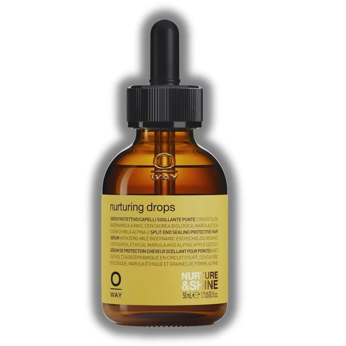A brown glass bottle with a black dropper cap containing nurturing drops for hair, with a yellow label describing the product in multiple languages.