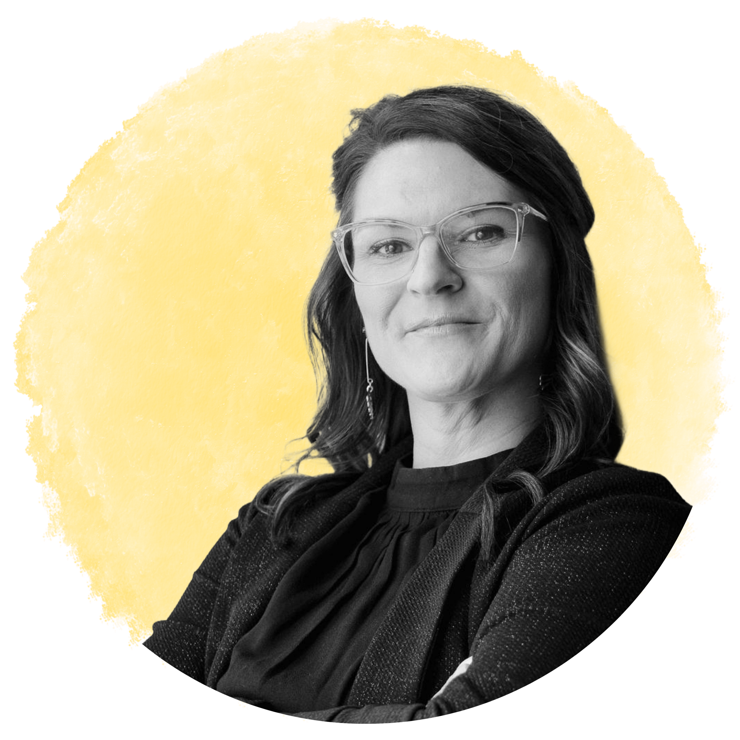 A close-up black and white portrait of a middle-aged woman with shoulder-length hair, wearing glasses, against a yellow background.