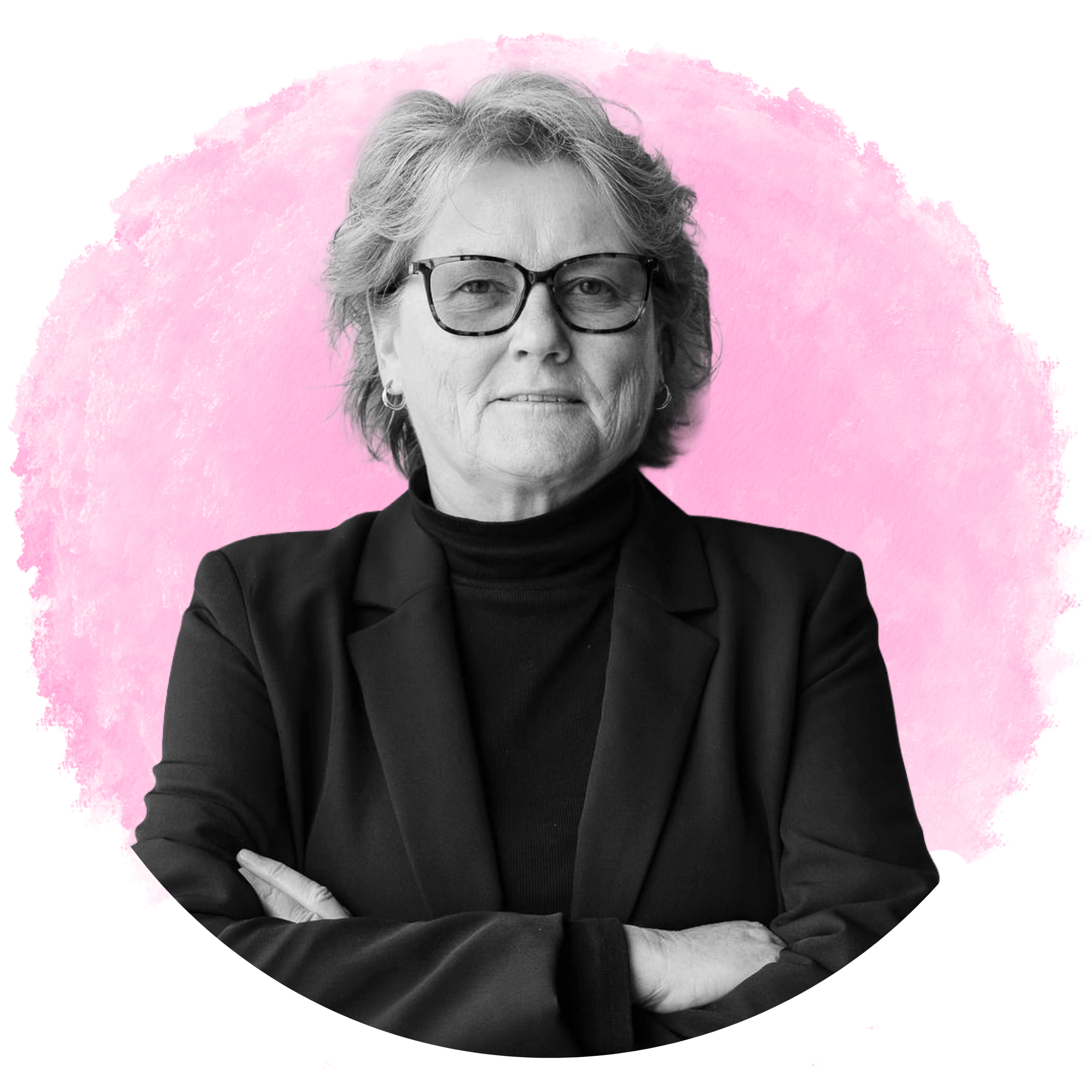 Black and white portrait of an older woman with short wavy hair and glasses, wearing a turtleneck and blazer, with crossed arms, against a pink background.