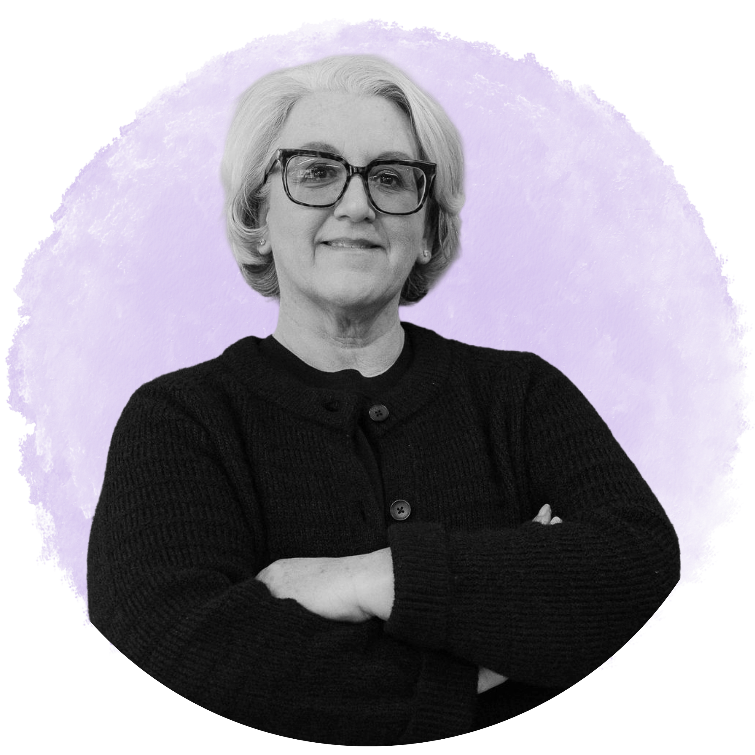 A woman with gray hair and glasses looking slightly off-camera, wearing a black sweater against a purple background.
