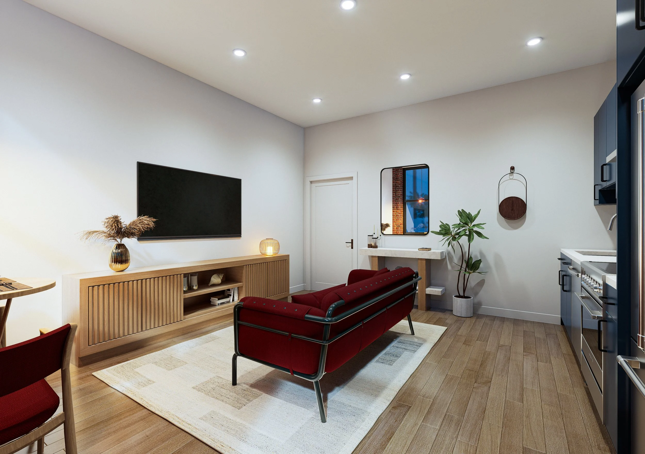 Modern living room with white walls, wooden flooring, a wooden TV stand, a flat-screen TV, red seating, a potted plant, a window with a brick wall outside, and decorative items including a vase and lamps.
