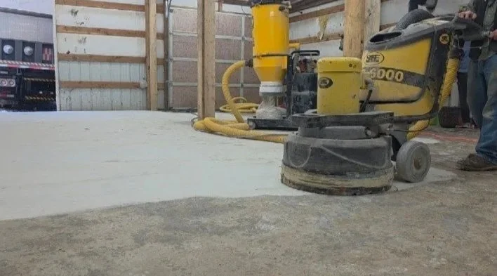 Industrial concrete polishing machine in a construction site with a partially polished concrete floor.