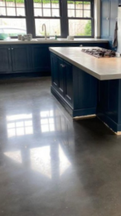 Modern kitchen with blue cabinets, white countertops, and large windows
