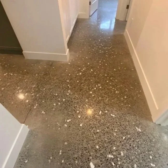 Kitchen floor with scattered white food particles or debris.