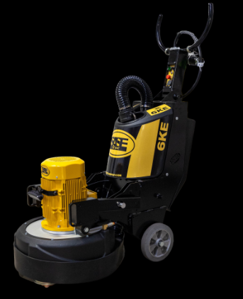 A yellow and black industrial floor grinding machine with wheels, hoses, and control buttons on a black background.
