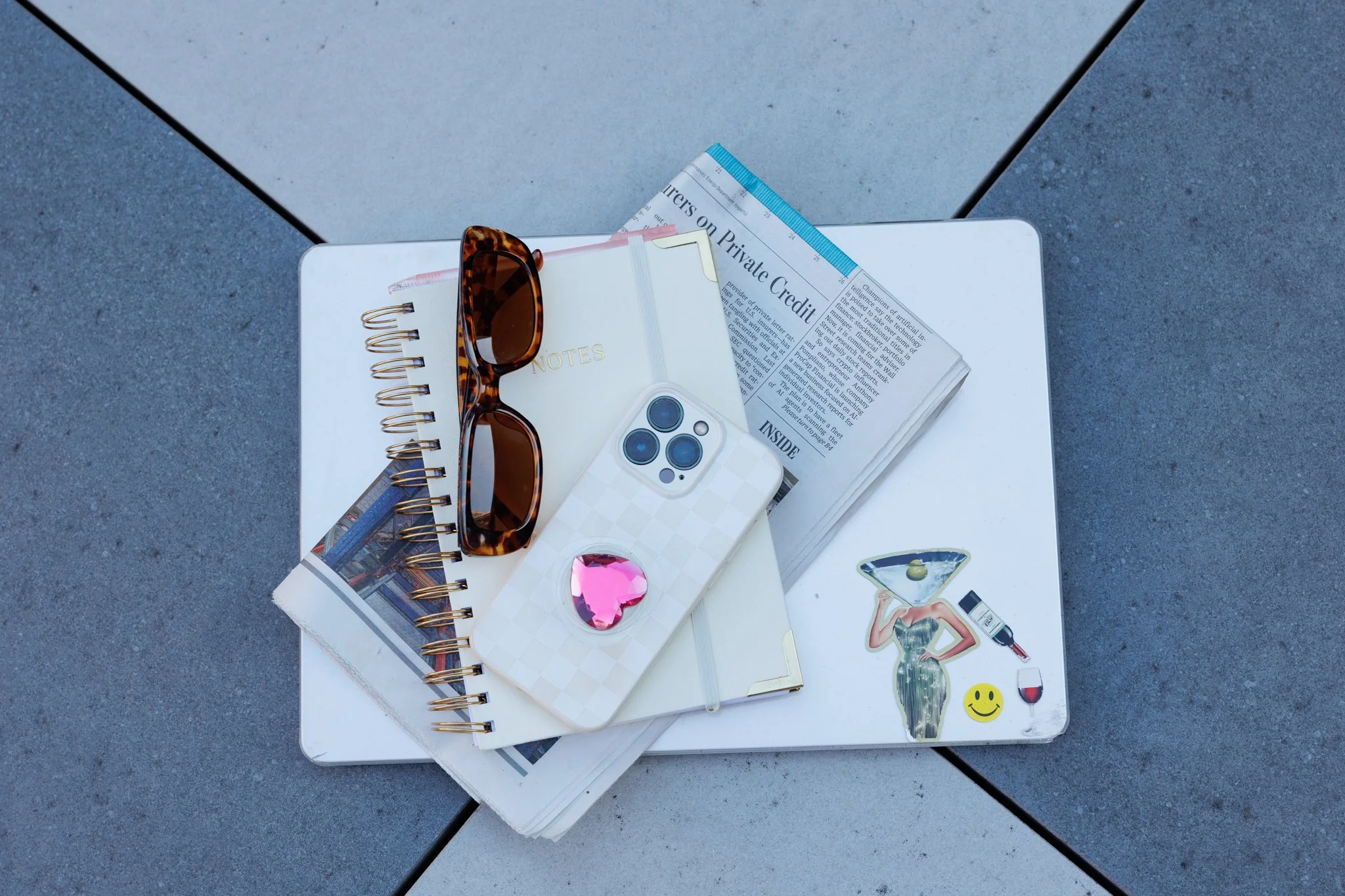 laptio phone newspaper notepad