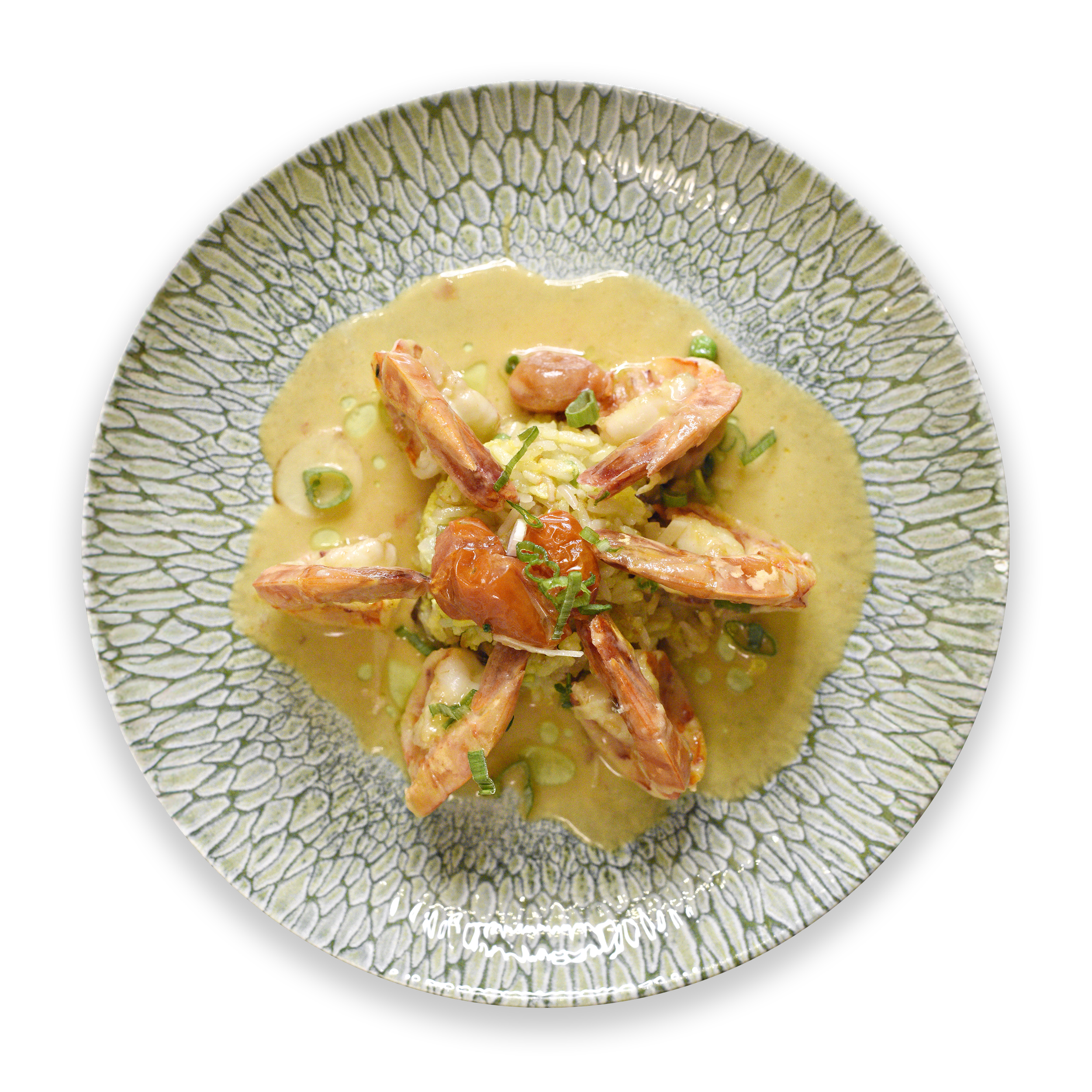 Café Nelo — A decorative bowl with a cracked glaze pattern, containing a creamy soup garnished with green herbs and topped with shrimp.