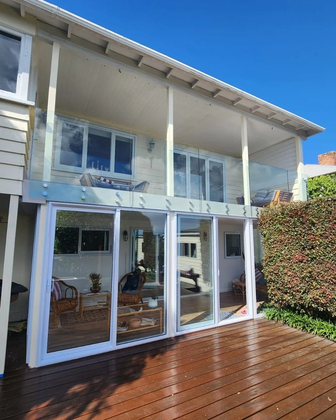 Installation complete and what a stunning result! 
We transformed an existing space under the balcony into a well utilised conservatory. 
We used double glazed aluminium panels and sliding doors to create this amazing space. 
Glass balustrades on the